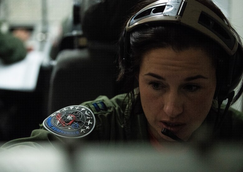 U.S. Air Force Capt. Breann Turner, 961st Airborne Air Control Squadron electronic combat officer, coordinates the electronic air battle aboard an E-3 Sentry during Exercise WestPac Rumrunner out of Kadena Air Base, Japan, Jan. 10, 2020. WestPac Rumrunner represents an evolution of 18th Wing assets and capability to work with joint partners in defense of American allies and to ensure a free and open Indo-Pacific. (U.S. Air Force photo by Staff Sgt. Daniel Fernandez)