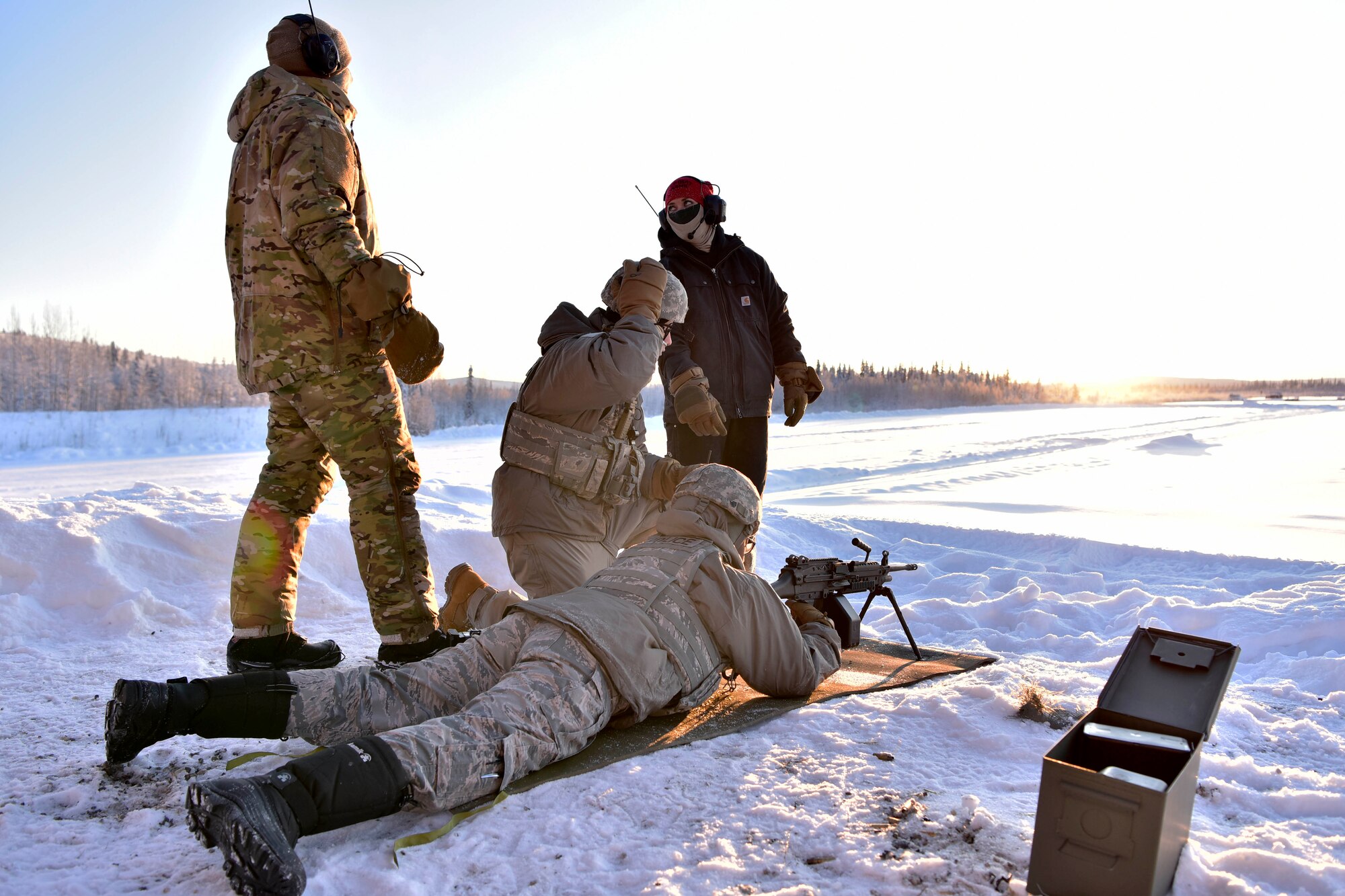354th Security Forces Squadron Combat Arms Training and Maintenance instructors prepare Airmen to fire an M-249 Squad Automatic Weapon at Eielson Air Force Base, Alaska, Jan. 9, 2020. CATM instructors are responsible for training the 354th Fighter Wing how to use various small arms weapon systems. (U.S. Air Force photo by Senior Airman Beaux Hebert)