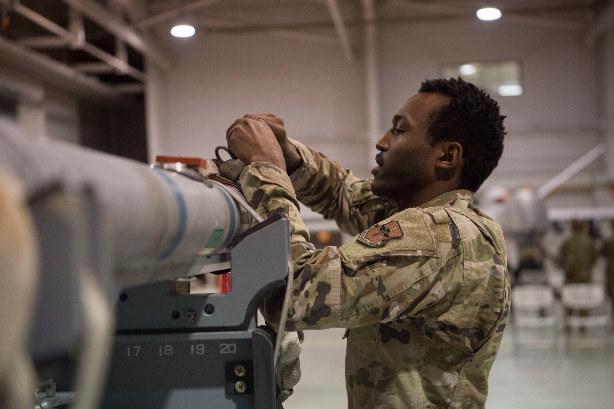 A load crew member from the 311th Fighter Squadron prepares an inert bomb for an F-16 Viper, Jan. 10, 2020, on Holloman Air Force Base, N.M. 12 Airmen from the 9th Aircraft Maintenance Unit, 29th AMU, 314th FS and 311th FS competed to see who could load munitions onto their respective aircraft the fastest. (U.S. Air Force photo by Airman 1st Class Quion Lowe)