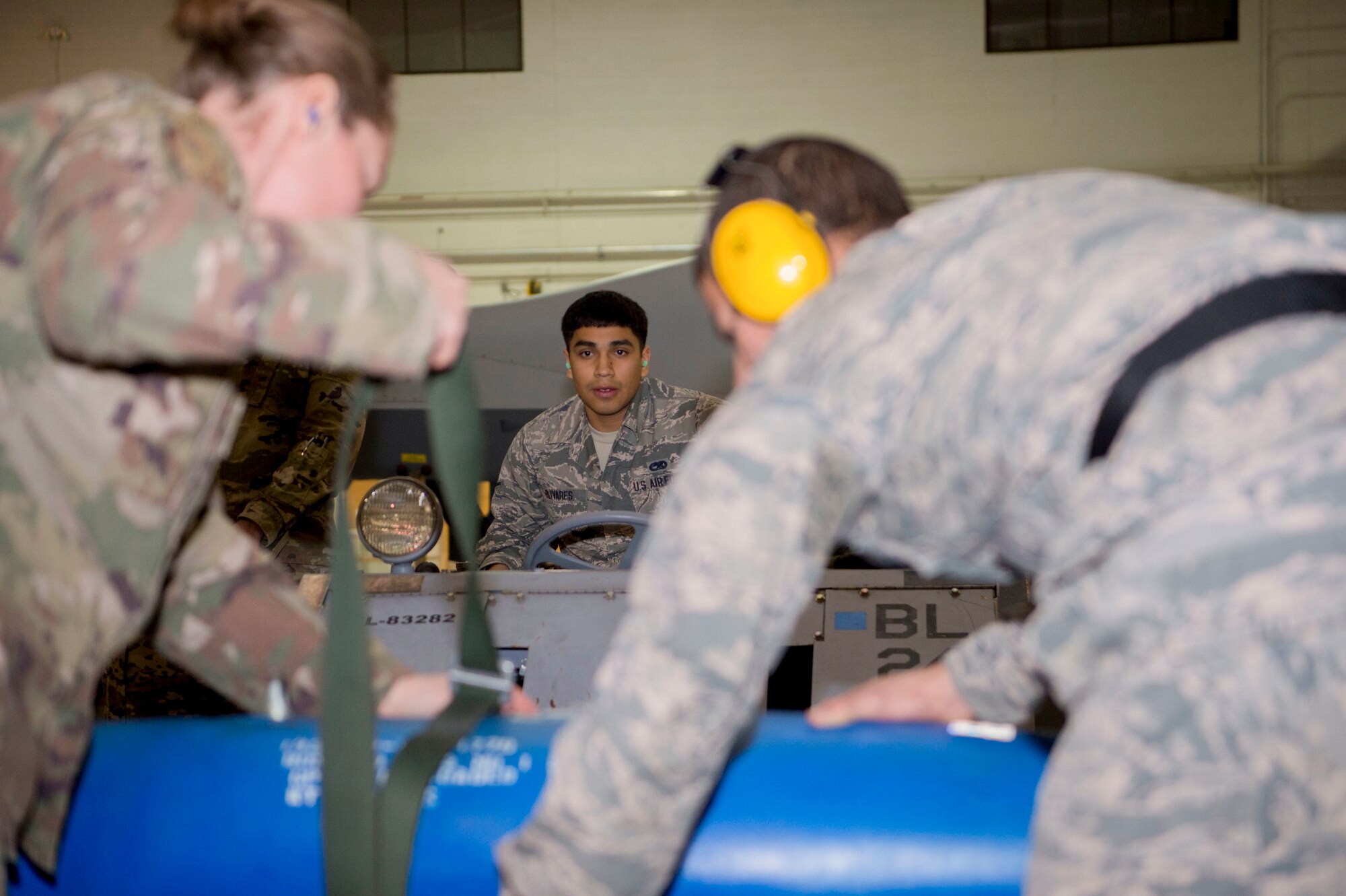 Load crew members from the 9th Aircraft Maintenance Unit prepare to load an inert bomb onto an MQ-9 Reaper, Jan. 10, 2020, on Holloman Air Force Base, N.M. 12 Airmen from the 9th AMU, 29th AMU, 314th Fighter Squadron and 311th FS competed to see who could load munitions onto their respective aircraft the fastest. (U.S. Air Force photo by Airman 1st Class Quion Lowe)