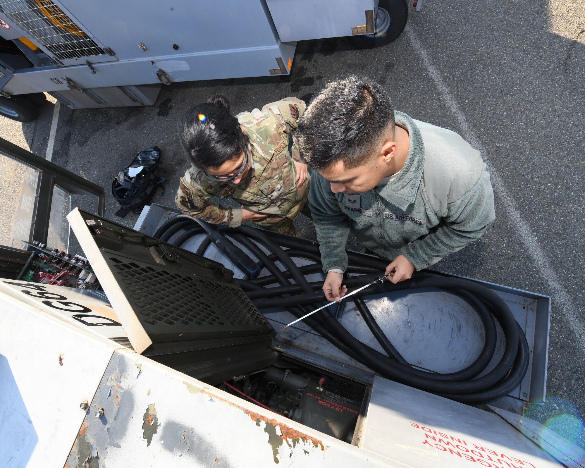 Senior Airman Miguel Fraire, 9th Maintenance Squadron aerospace ground equipment technician, and Senior Airman Sierra Garcia, 9th MXS AGE apprentice, inspect the oil on a generator, Jan. 7, 2020 at Beale Air Force Base California. These professionals play a big role on helping the 9th Reconnaissance Wing accomplish its mission by providing the needed equipment to requesting units. (U.S. Air Force photo by Airman 1st Class Luis A. Ruiz-Vazquez)