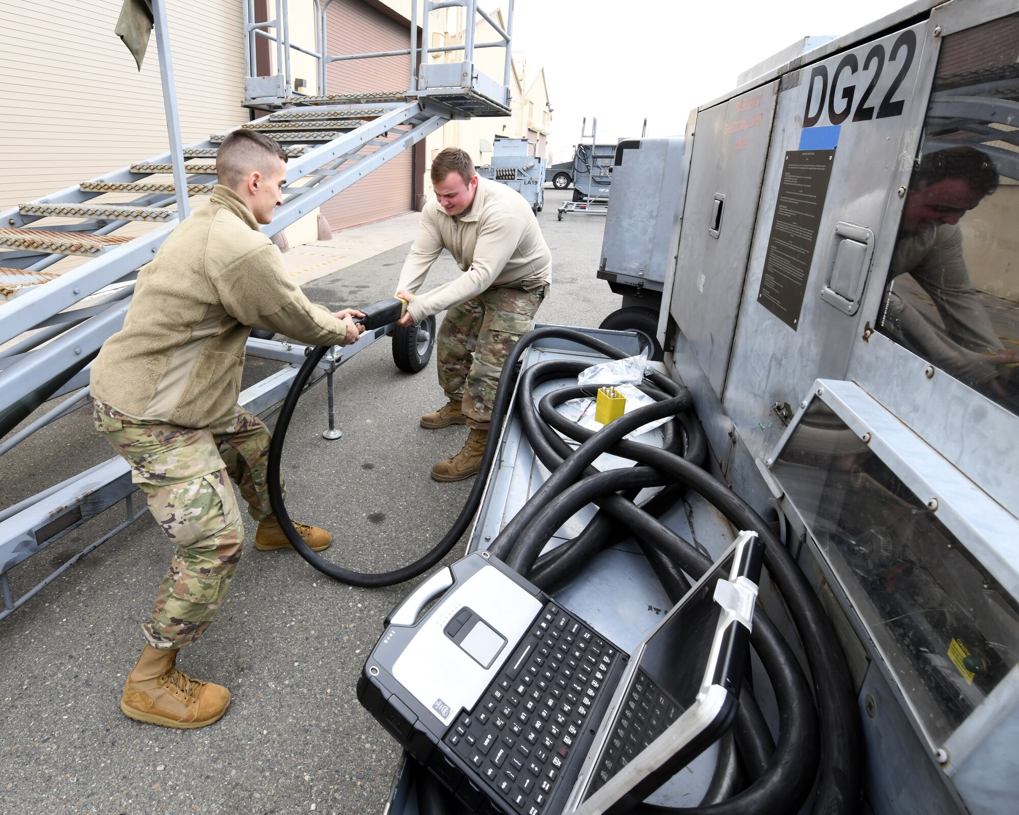 Senior Airman Alec Bowman, 9th Maintenance Squadron aerospace ground equipment apprentice, and Staff Sgt. Hunter Layton 9th MXS AGE journeyman, remove an AC cable head, Jan. 7, 2020 at Beale Air Force Base California. AGE works with equipment ranging from air conditioning units to equipment that supplies electricity, hydraulic pressure, and air pressure to aircraft. (U.S. Air Force photo by Airman 1st Class Luis A. Ruiz-Vazquez)