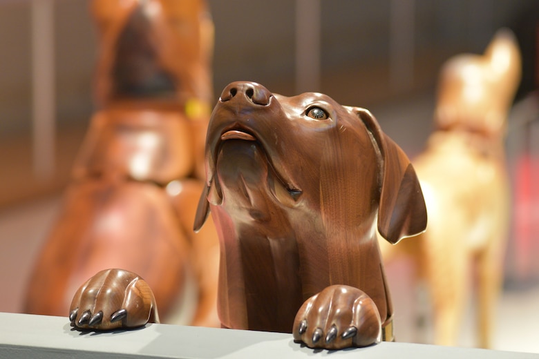 Photo of a wooden dog carving.