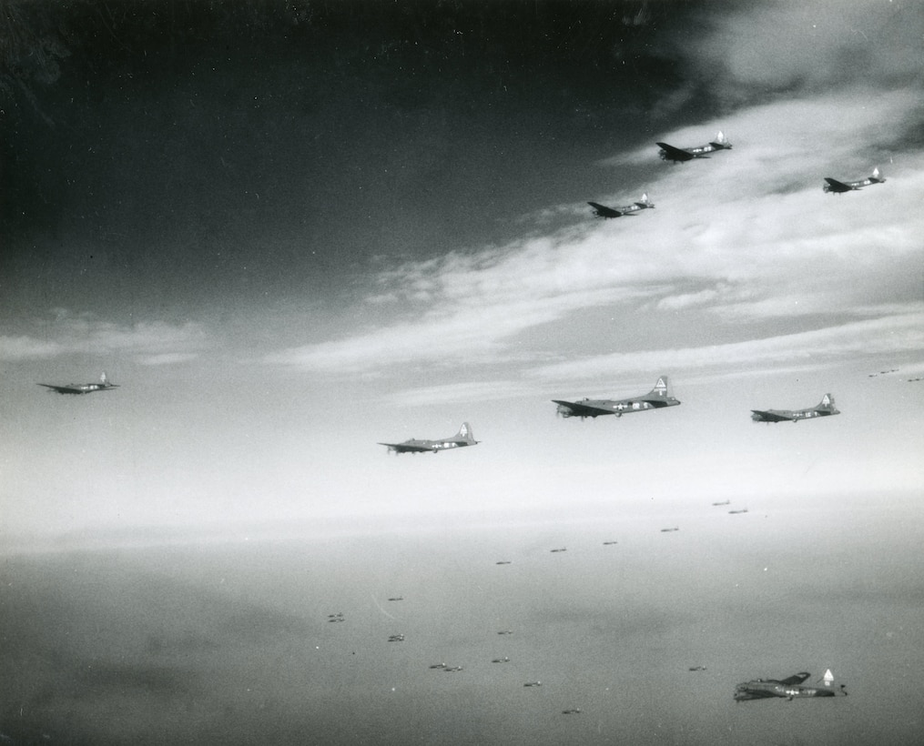 Dozens of aircraft fly in formation against a grey sky.