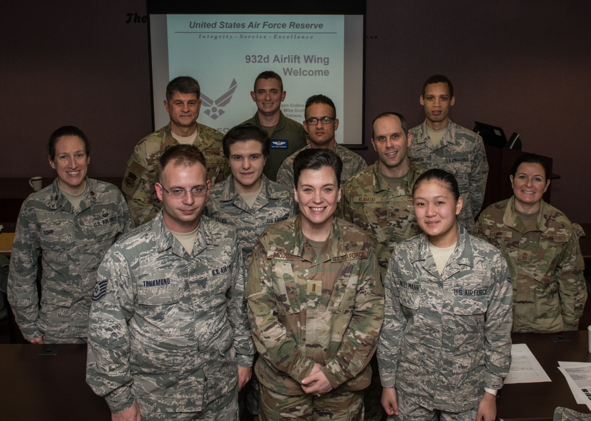 932nd Airlift Wing commander, Col. Glenn Collins, left, rear row, along with Command Chief Barbara Gilmore, far right, take a photo moment with the newest Citizen Airmen to join the 932nd AW family, Jan. 11, 2020, Scott Air Force Base, Illinois at the monthly newcomers briefing.  Each unit training assembly leadership greets, shares the 932nd AW mission, organization chart and answers questions as a welcome to the Wing.  (U.S. Air Force photo by Master Sgt. Christopher Parr)
