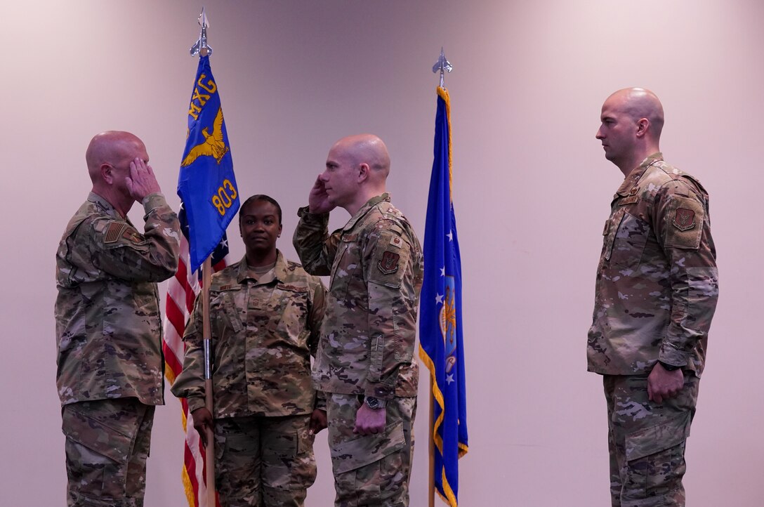 Lt. Col. Brian Horton, outgoing 803rd 803rd Aircraft Maintenance Squadron commander, relinquishes command to Col. Jay Johnson, 403rd Maintenance Group commander, as incoming commander, Maj. Matthew Goldey, looks on at the Roberts Consolidated Aircraft Maintenance Facility at Keesler Air Force Base, Miss. Jan. 11, 2020. Horton will be continuing his career at Eglin Air Force Base, Fla. (U.S. Air Force photo by Senior Airman Kristen Pittman)