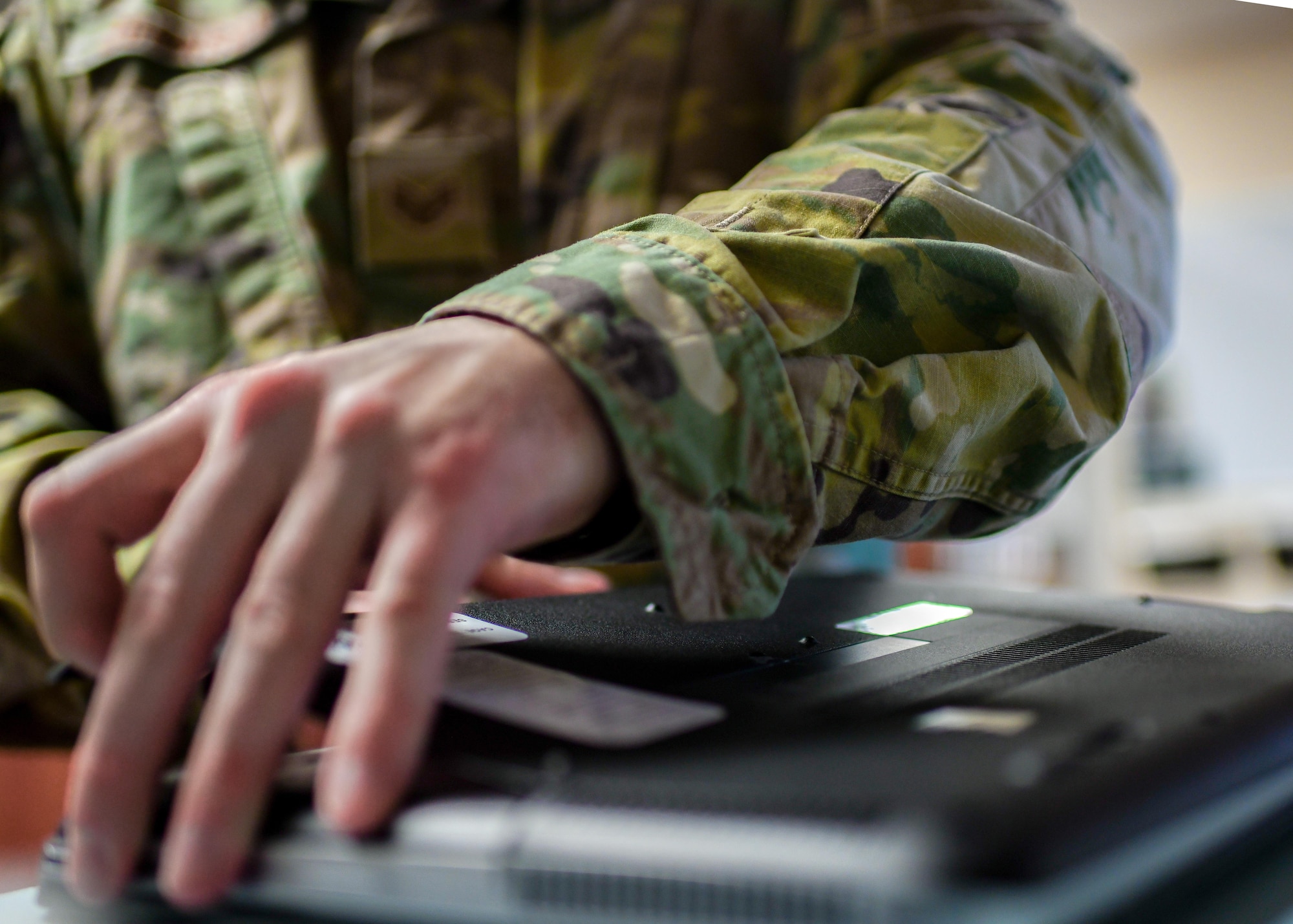 Staff Sgt. David Johnson, a client systems technician assigned to the 910th Communications Squadron, opens the bottom of a laptop to replace the battery, Jan. 11, 2019, at Youngstown Air Reserve Station.