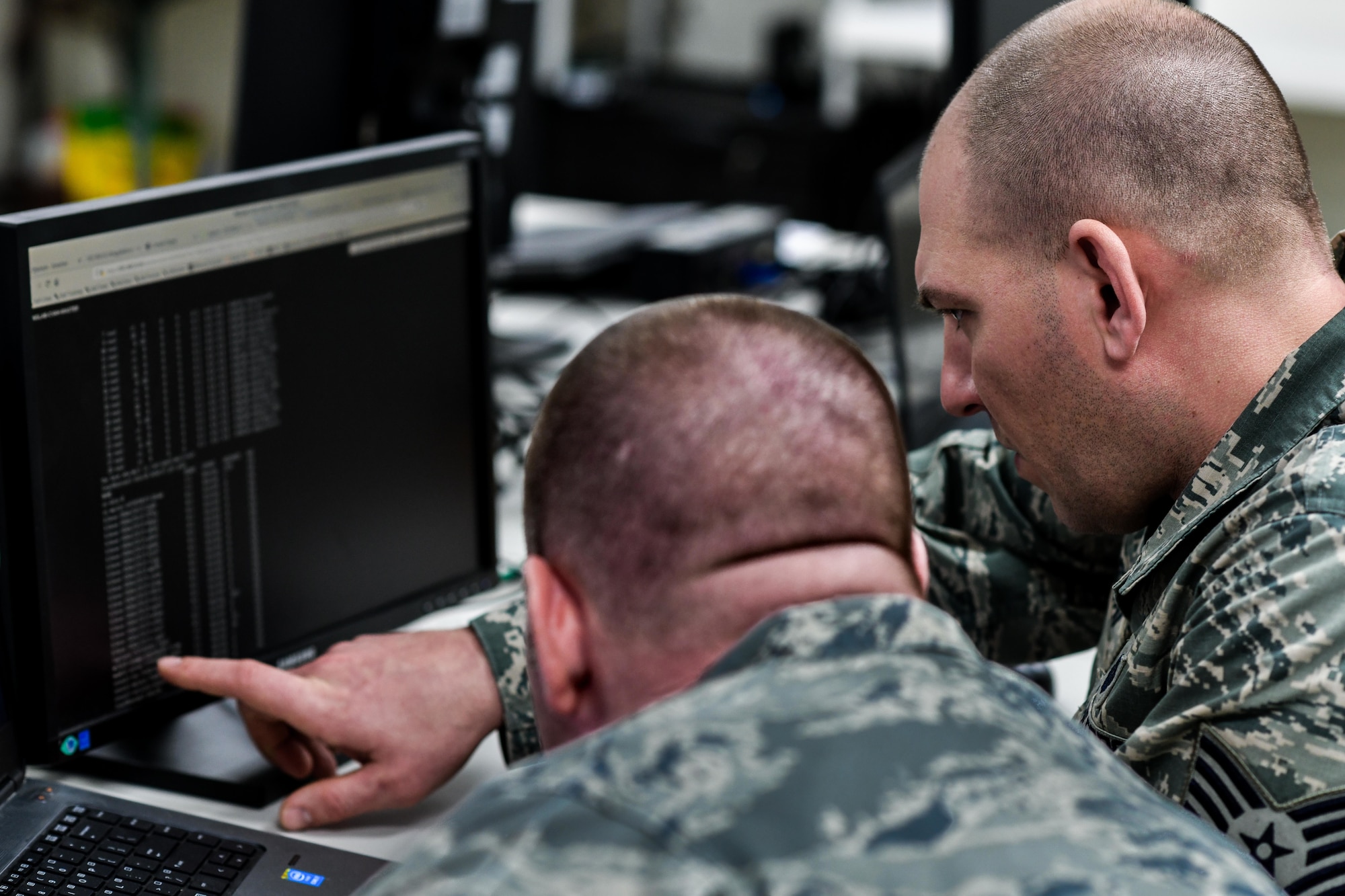 Tech Sgt. Scott Ranostay, a cyber systems operator, and Tech Sgt. Lawrence Mulder, a communications computer systems operator, both assigned to the 910th Communications Squadron, troubleshoot their lab environment with a Cyber Vulnerability Assessment Hunt weapon system, Jan. 11, 2019, at Youngstown Air Reserve Station.
