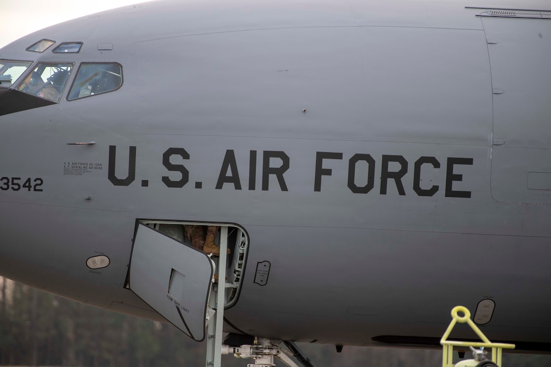 U.S. Air Force Staff Sgt. Jose A. Reyes, a 911th Air Refueling Squadron (ARS) dedicated crew chief, boards the aircraft upon completion of pre-flight checks before takeoff from Seymour Johnson Air Force Base, North Carolina, Dec. 12, 2019. This marks the last boots off the ground before the 911 ARS depart for their final mission on a KC-135 Stratotanker. (U.S. Air Force photo by Staff Sgt. Mary McKnight)