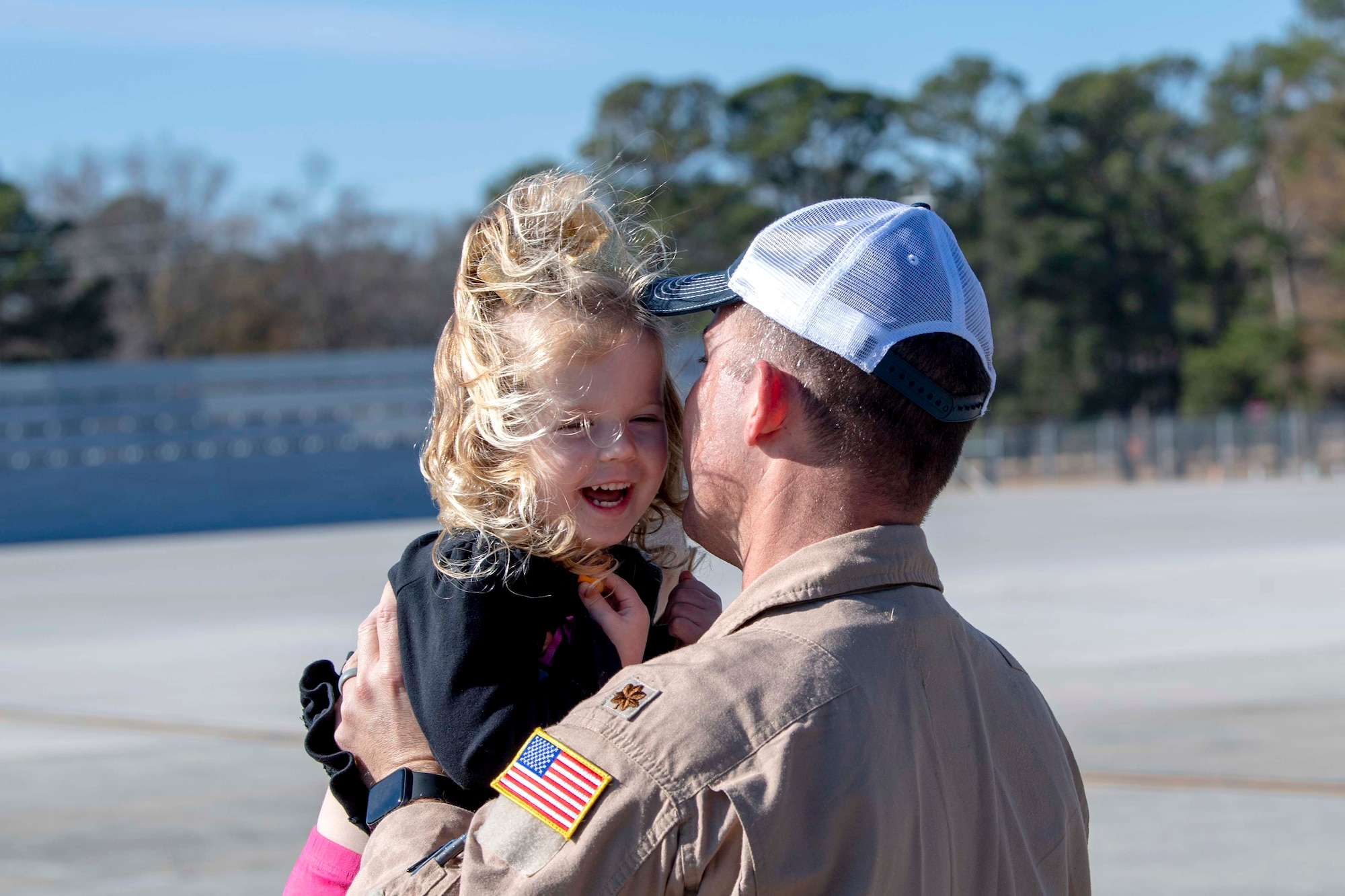 U.S. Air Force Maj. Marc Johnson, a 911th Air Refueling Squadron (ARS) pilot, picks up his daughter Ellie, on the flightline on Seymour Johnson Air Force Base, North Carolina, Dec. 16, 2019. The 911 ARS completed their final mission on a KC-135 Stratotanker. (U.S. Air Force photo by Staff Sgt. Mary McKnight)