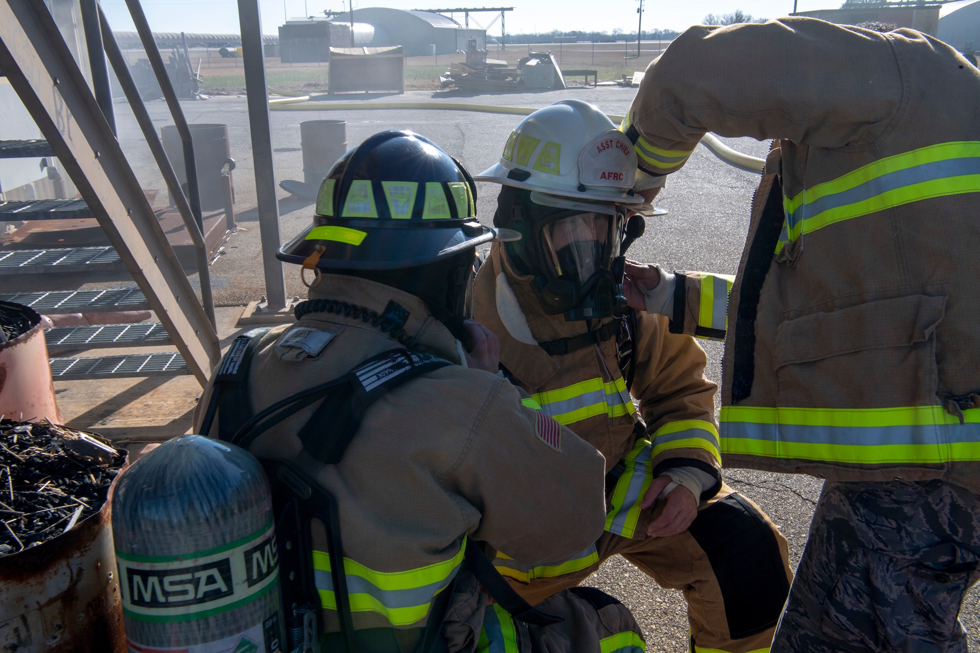 U.S. Air Force Senior Airman Kyler Rogers-McCoy and Airman 1st Class Ryann Baker, both 916th Civil Engineer Flight firefighters, simultaneously completes a buddy check on Lt. Col. Joseph Winchester, 916th Mission Support Group commander during a simulated live-fire training on Seymour Johnson Air Force Base, North Carolina, Jan. 9, 2020. Buddy checks are mandatory for any firefighter prior to making entry on any fire scene. (U.S. Air Force photo by Staff Sgt. Mary McKnight)