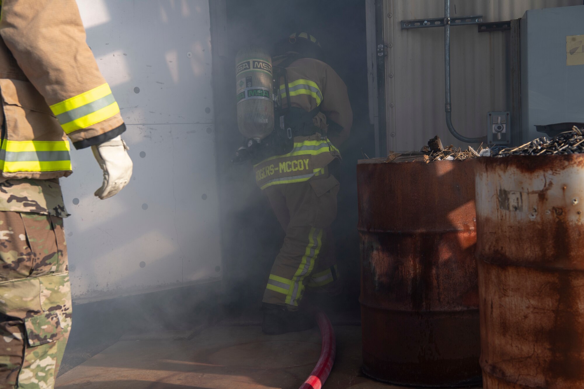 U.S. Air Force Senior Airman Kyler Rogers-McCoy, a 916th Civil Engineer Flight firefighter, makes re-entry into the building to regain contact with his crew on Seymour Johnson Air Force Base, North Carolina, Jan. 9, 2020. In a smoke-filled environment firefighters must maintain visual or voice contact with each other at all times. (U.S. Air Force photo by Staff Sgt. Mary McKnight)