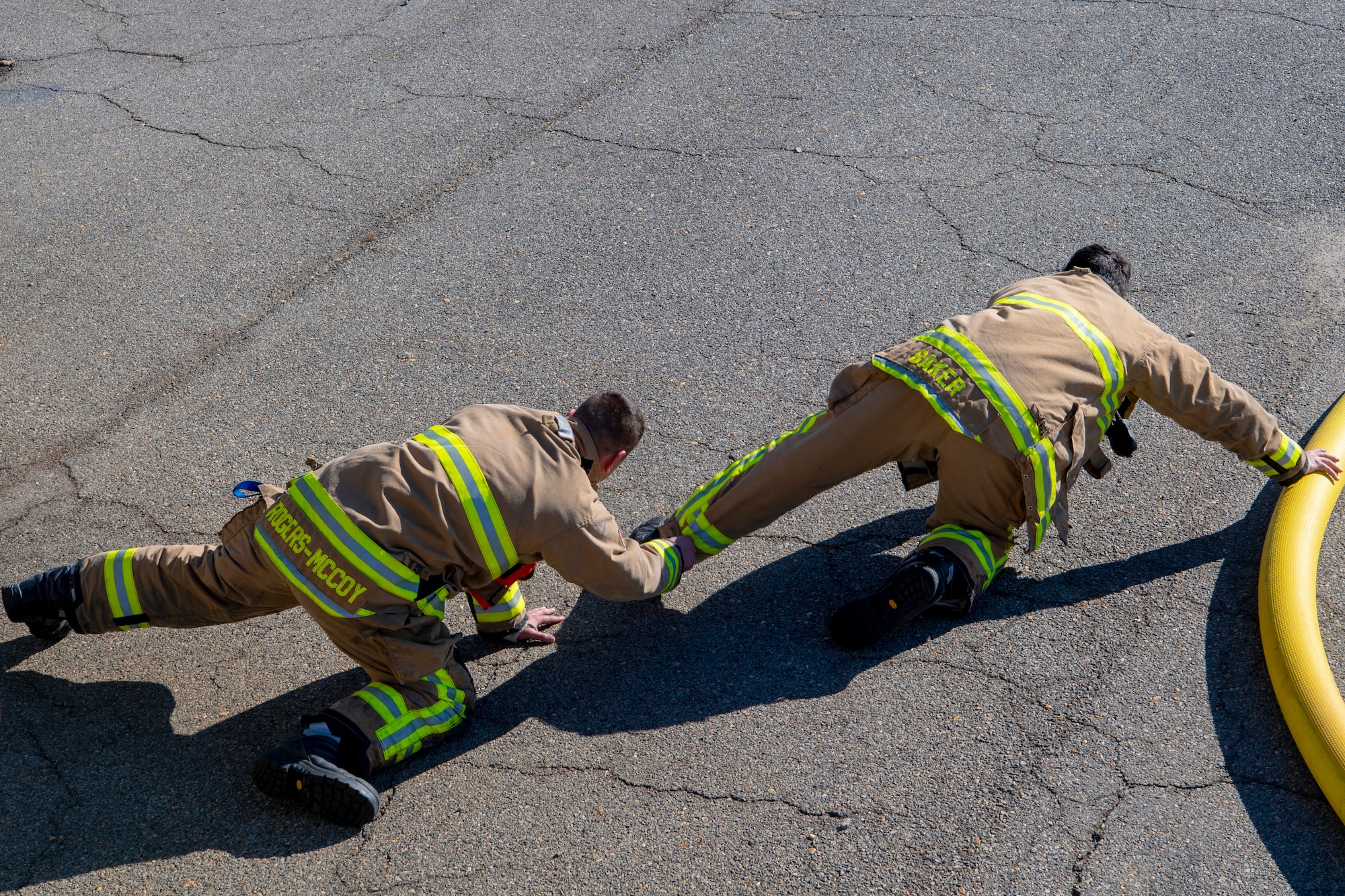 U.S. Air Force Senior Airman Kyler Rogers-McCoy and Airman 1st Class Ryann Baker, both 916th Civil Engineer Flight firefighters, demonstrates how to search for a victim off of a hose line on Seymour Johnson Air Force Base, North Carolina, Jan. 9, 2020. This technique is used to maximize coverage, without breaking contact, while searching in a large room. (U.S. Air Force photo by Staff Sgt. Mary McKnight)