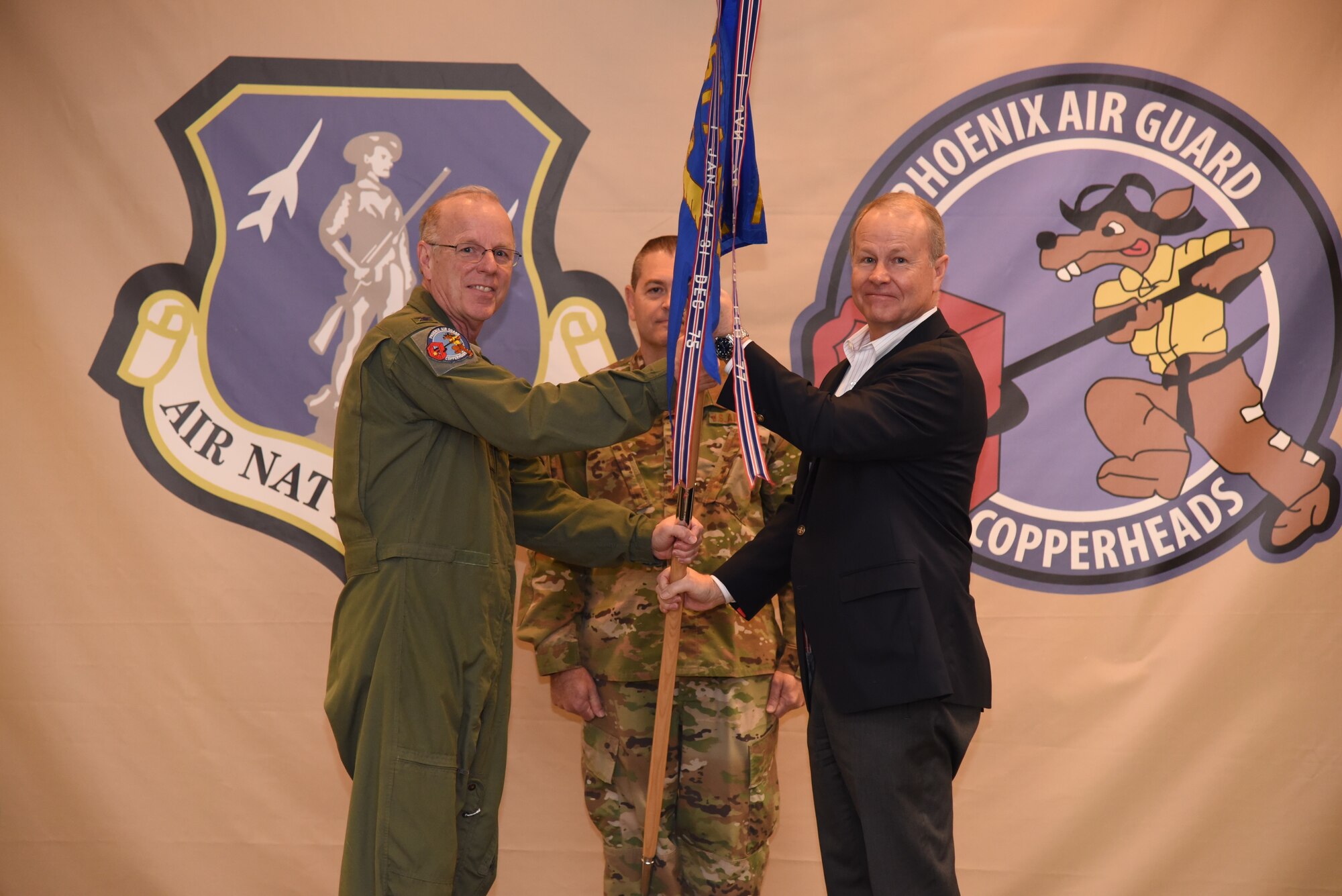 Col. John Rummel, 161st Air Refueling Wing Medical Group Squadron commander, passes the guidon to Mr. Steve Purves during the Honorary Commander Induction ceremony,
Nov. 2. During the ceremony, six honorary commanders were inducted. (U.S. Air National Guard photo by Tech. Sgt. Anthony Reynolds)