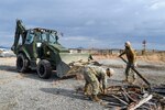 IWAKUNI, Japan (Jan. 8, 2020) Equipment Operator 3rd Class Marco Padilla, from San Antonio, and Equipment Operator 3rd Class Micheal King, from St. Stephen, South Carolina, deployed with Naval Mobile Construction Battalion (NMCB) 5’s Detail Iwakuni, put logs into the bucket of backhoe to clean the project site. U.S. Navy Seabees with NMCB-5’s Detail Iwakuni are constructing a landfill capping project in support of Marine Corps Air Station Iwakuni. NMCB-5 is deployed across the Indo-Pacific region conducting high-quality construction to support U.S. and partner nations to strengthen partnerships, deter aggression, and enable expeditionary logistics and naval power projection.