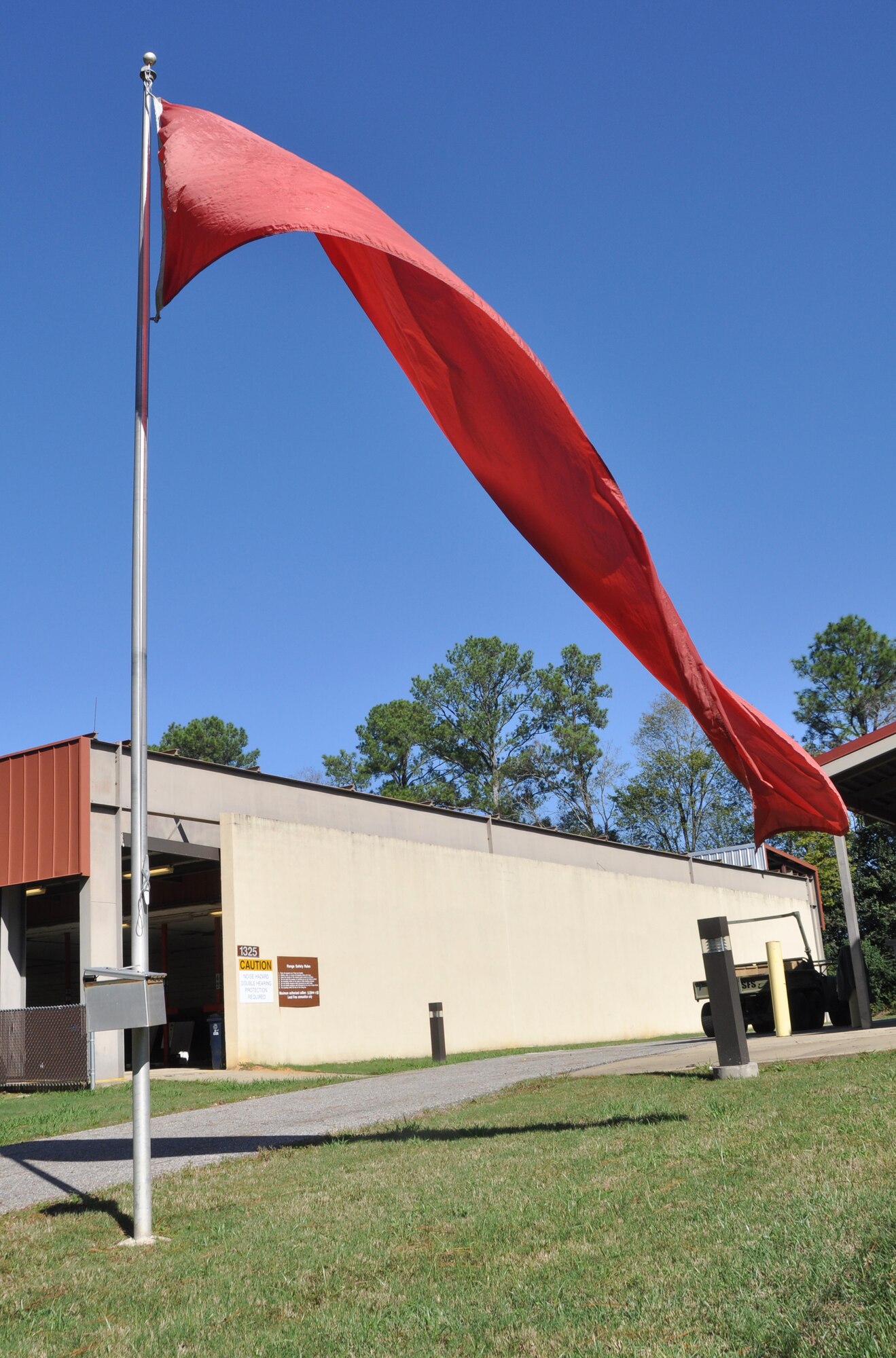 The red flag flies at the firing range, Nov. 2, 2019, at Maxwell AFB, Alabama. The red flag being flown as a range safety regulation indicates live firing is in progress. (U.S. Air Force photo by Airman 1st Class Shelby S. Thurman)
