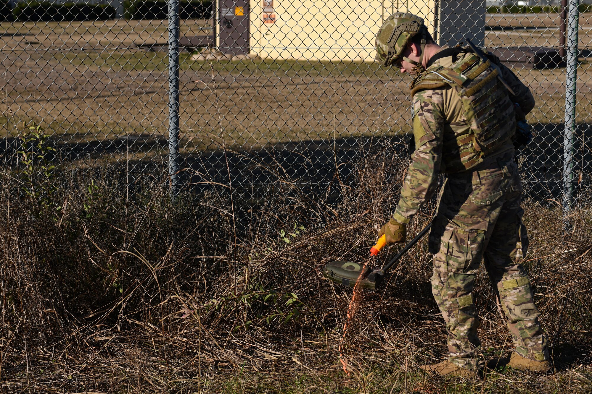 U.S. Air Force Staff Sgt. Jackson Judge, explosive ordnance team member from the 31 Civil Engineer Squadron, squeezes marking chalk during an training exercise at Aviano Air Base, Italy, Jan. 8, 2020. Marking chalk is used to mark a clear path or hazards. (U.S. Air Force photo by Airman 1st Class Ericka A. Woolever).