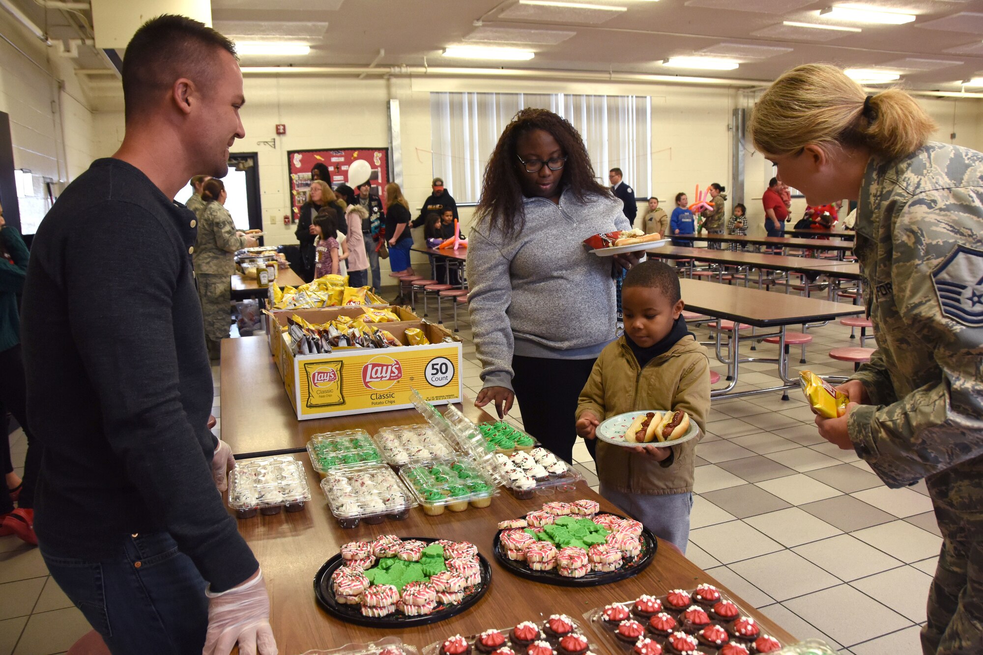 Volunteers from the North Carolina Air National Guard (NCANG) assist students with a hot lunch at Badin Elementary School (B.E.S.) during Operation Santa held at B.E.S., Badin, N.C., Dec. 14th, 2019.  Operation Santa is an annual event run by the Chapter 7 organization of the NCANG which chooses select schools to provide assistance to families during the holiday season. This year, the NCANG provided presents, lunch, music, bouncy castles and a Santa. The NCANG also partnered with the local Target for food donations.