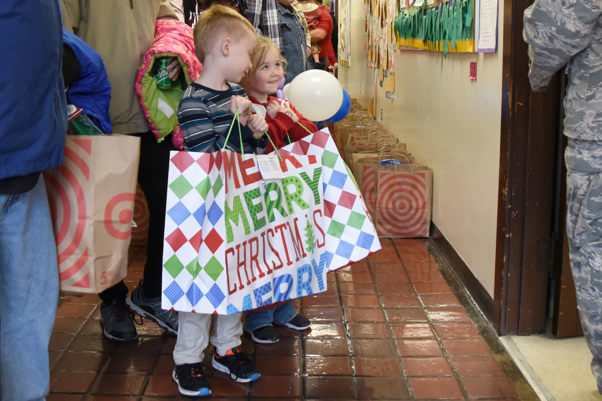 Young students of Badin Elementary School (B.E.S.) receive presents during Operation Santa held at B.E.S., Badin, N.C., Dec. 14th, 2019.  Operation Santa is an annual event run by the Chapter 7 organization of the North Carolina Air National Guard (NCANG) which chooses select schools to provide assistance to families during the holiday season. This year, the NCANG provided presents, lunch, music, bouncy castles and a Santa. The NCANG also partnered with the local Target for food donations.