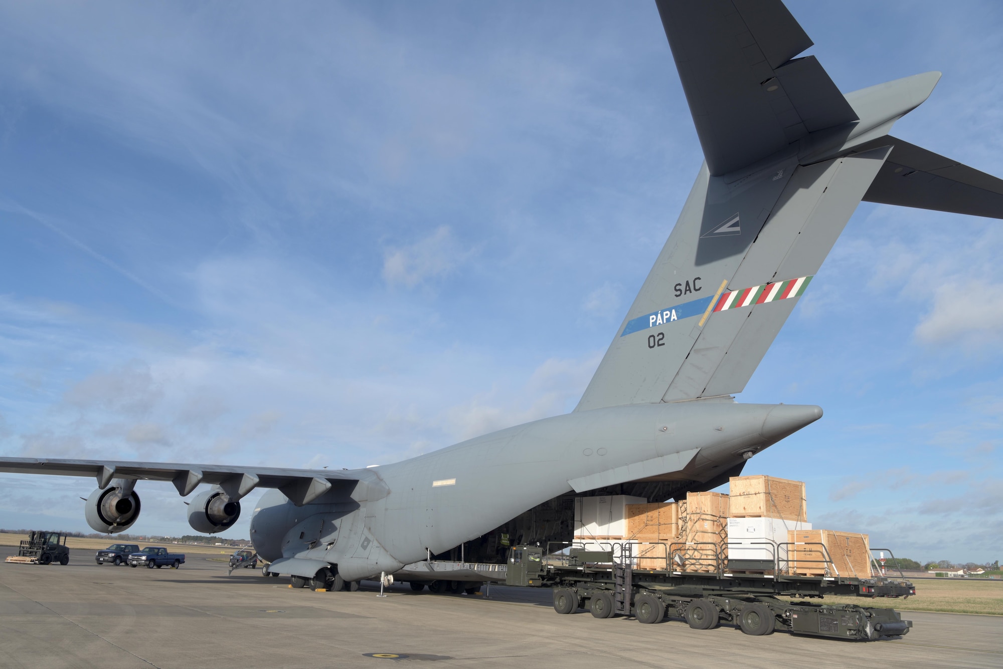 Civilians with the 727th Air Mobility Squadron offload the Boom Operator Weapon System Trainer from a C-17 Globemaster III assigned to the Heavy Airlift Wing, Pápa Air Base, Hungary, at RAF Mildenhall, England, Jan. 11, 2020. The BOWST trains boom operators for real-world operations while saving money and flying hours. (U.S. Air Force photo by Senior Airman Benjamin Cooper)