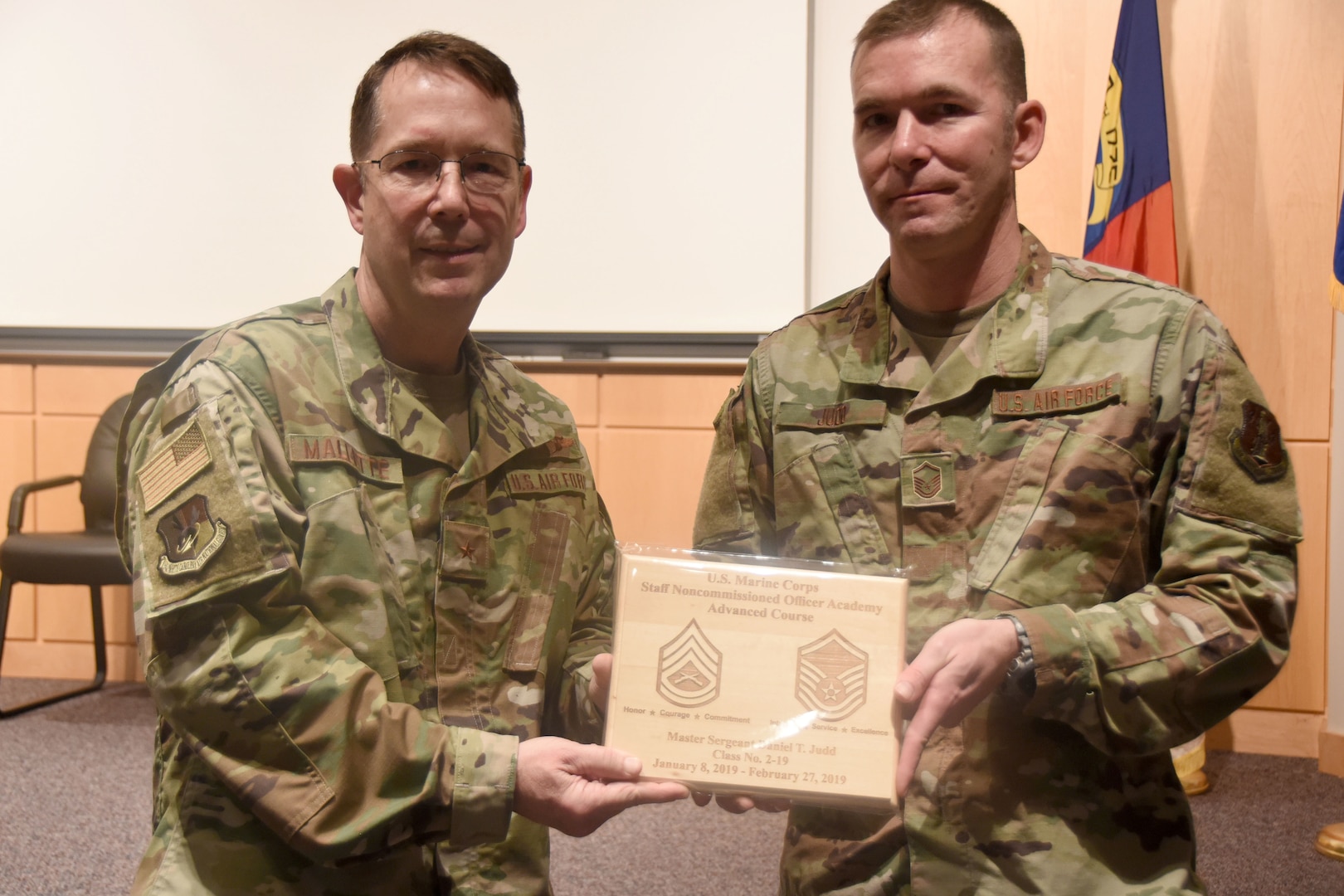 Brig. Gen. Stephen Mallette, left, North Carolina Air National Guard assistant adjutant general for air, presents Master Sgt. Daniel Judd, 263rd Combat Communications Squadron, with an award at New London, N.C., Air National Guard Base headquarters, Jan. 12, 2020, for completing training at the United States Marine Corps Staff Non-Commissioned Officer Academy.