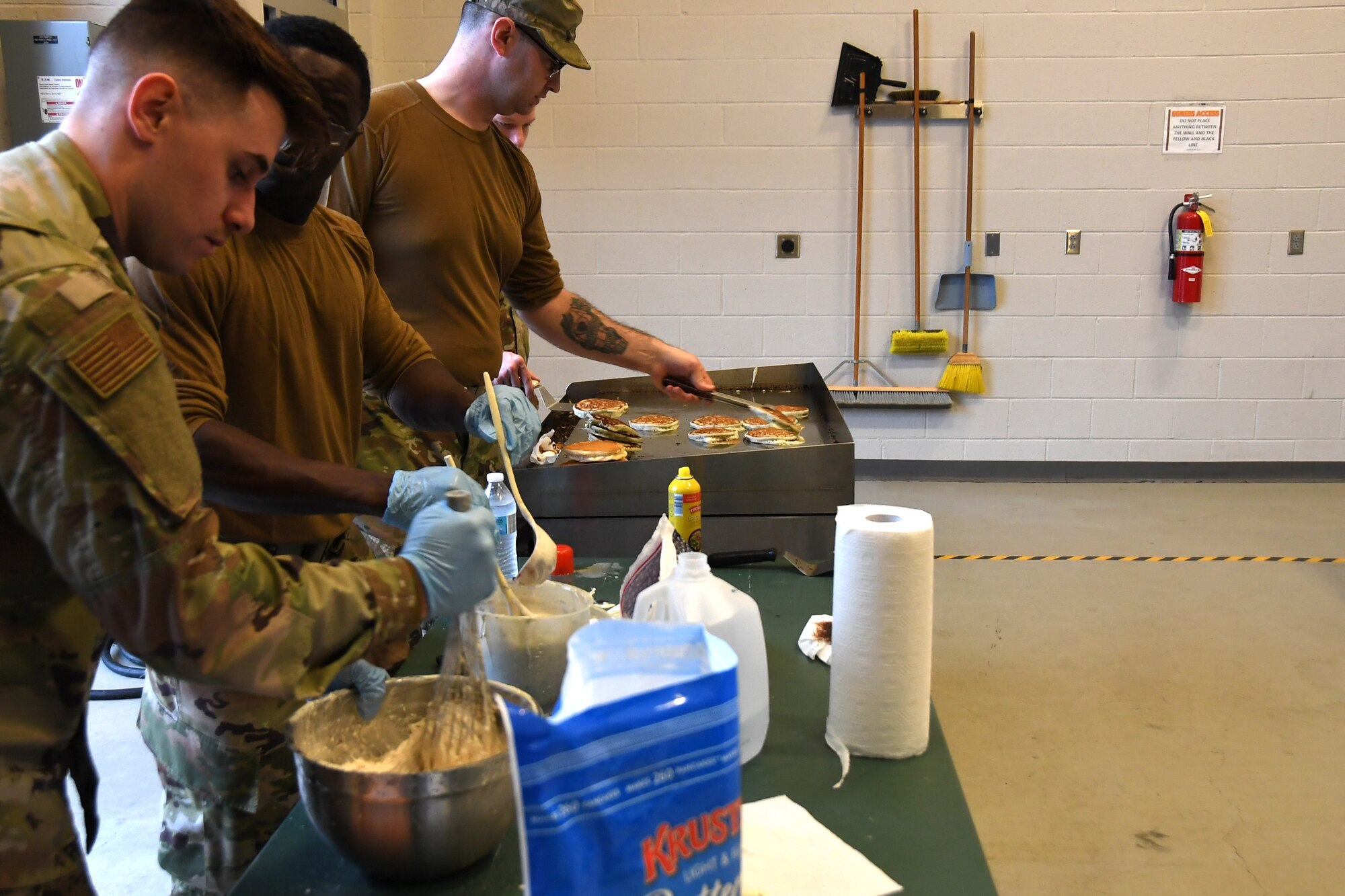 North Carolina Air National Guardsmen cook pancakes on a grill during a breakfast fundraiser, Jan. 12, 2020 at the 235th Air Traffic Control Squadron in New London, N.C. Members of the North Carolina Air National Guard as well as local airport authorities and law enforcement were invited to participate in a pancake breakfast social in order to strengthen community ties and build new relationships while raising funds for Morale, Welfare and Recreation.