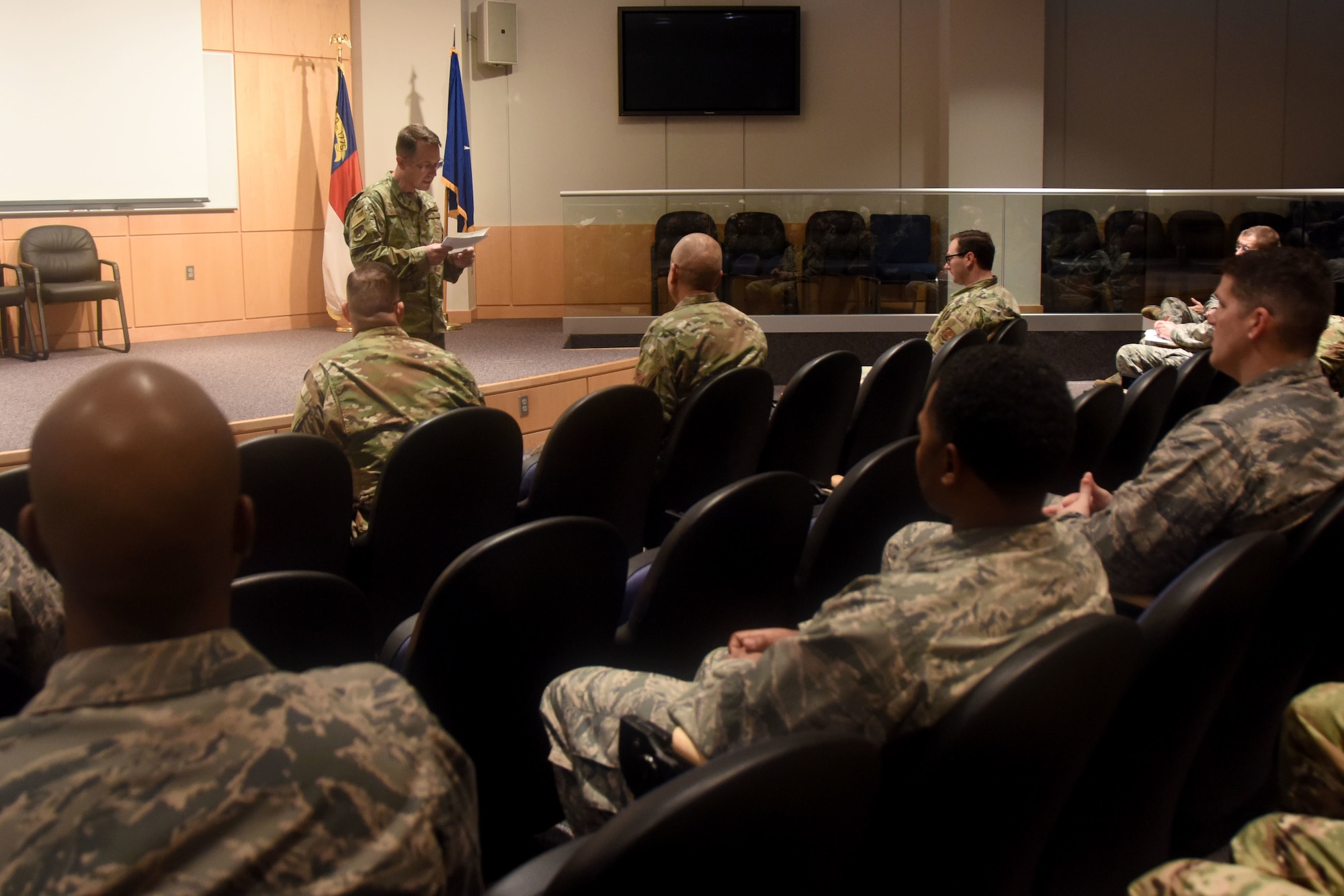 Members of the North Carolina Air National Guard listen as U.S. Air Force North Carolina Assistant Adjutant General for Air, Brig. Gen. Stephen Mallette delivers a speech before presenting Master Sgt. Daniel Judd and Master Sgt. Kernice Locklear, 263rd Combat Communications Squadron with awards during an all-call held at the New London, N.C. Air National Guard Base (NCANG) headquarters, Jan. 12, 2020. Members of the NCANG celebrated the accomplishments of Master Sgts. Judd and Locklear who attended the United States Marine Corps Staff Non-Commissioned Officer Academy last year in an effort to better understand the traditions and customs of a sister service. Since attending the academies, Judd and Locklear have implemented U.S. Marine Corps. practices such as sharing unit history and helping newer Airmen feel more involved with more responsibilities.