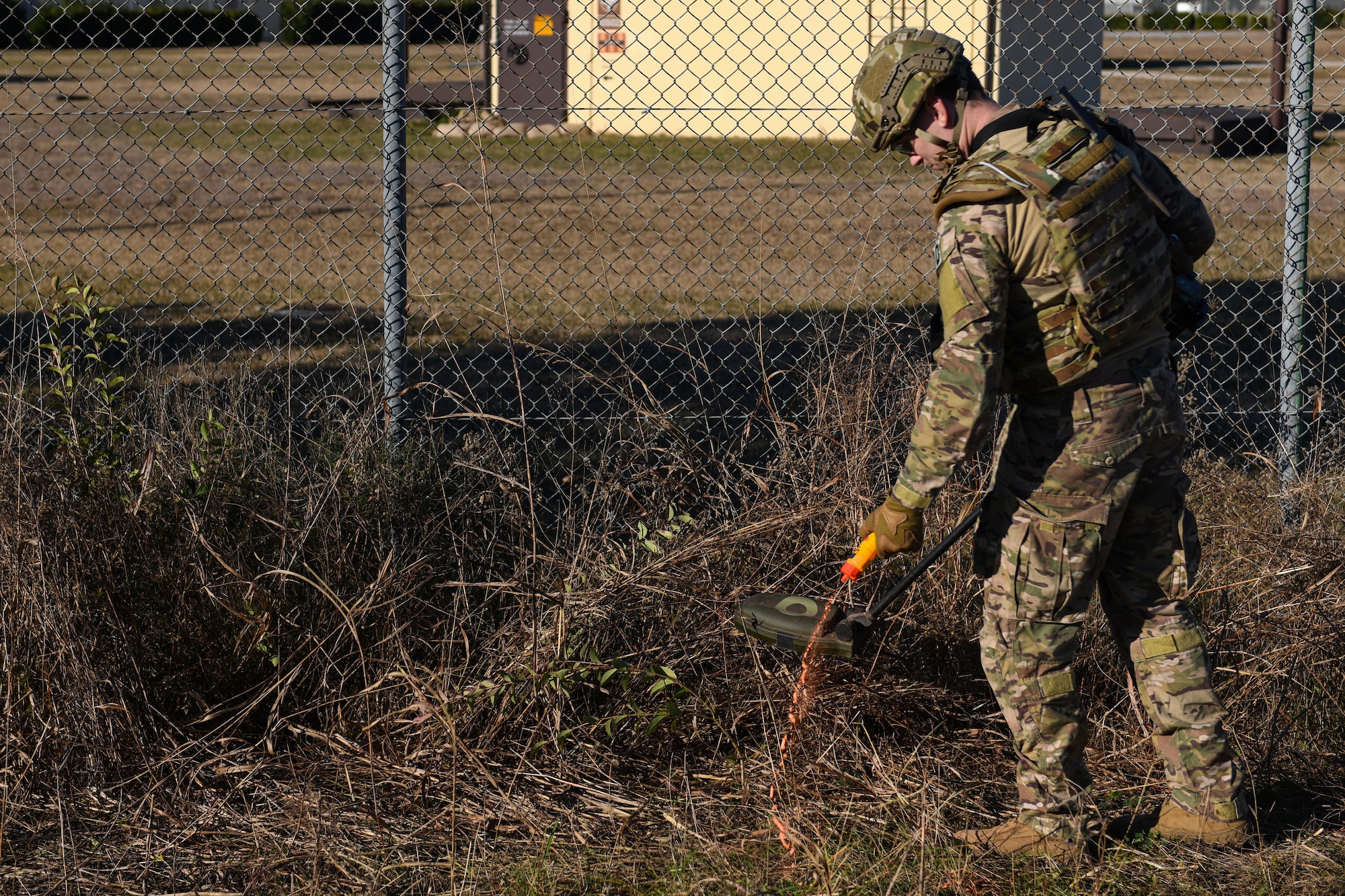 U.S. Air Force Staff Sgt. Jackson Judge, explosive ordnance team member from the 31 Civil Engineer Squadron, squeezes marking chalk during an training exercise at Aviano Air Base, Italy, Jan. 8, 2020. Marking chalk is used to mark a clear path or hazards. (U.S. Air Force photo by Airman 1st Class Ericka A. Woolever).