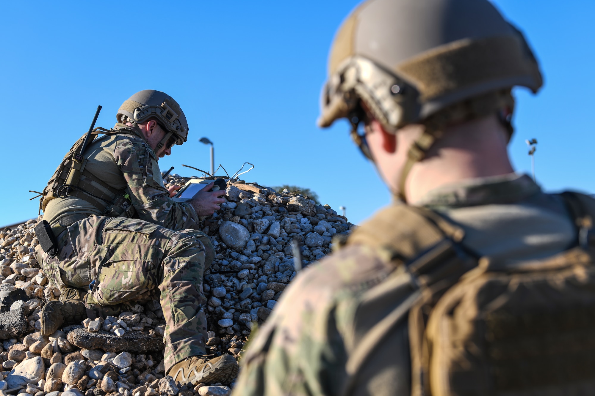 U.S. Air Force Airman 1st Class Tyler McConnell, left, and Senior Airman Colby Forsythe, explosive ordnance team members from the 31 Civil Engineer Squadron, attempt to reconnect the operation control unit to the Micro Tactical Ground Robot during a training exercise at Aviano Air Base, Italy, Jan. 8, 2020. EOD Airmen use the MTGR to carry out reconnaissance missions, identify objects from far distances, locate designated targets and breach a compound. (U.S. Air Force photo by Airman 1st Class Ericka A. Woolever).