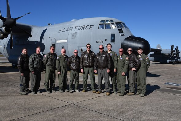Lt. Col. David Price, 53rd Weather Reconnaissance Squadron evaluator navigator, poses with the crew after completing his 'fini' flight with the squadron. After 35 years, both active duty and reserve, Lt. Col. Price will retire having flown in the 403rd Wing for both the tactical missions and storm missions. (U.S. Air Force photo by Jessica L. Kendziorek)