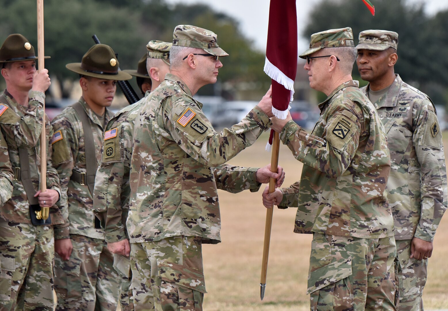 Lt. Gen. James E. Rainey (center), commanding general, U.S. Army Combined Arms Center, passes the MEDCoE colors to incoming commander Maj. Gen. Dennis P. LeMaster (left) as outgoing commander Maj. Gen. Patrick D. Sargent looks on during the U.S. Army Medical Center of Excellence change of command ceremony at Joint Base San Antonio-Fort Sam Houston Jan. 10.