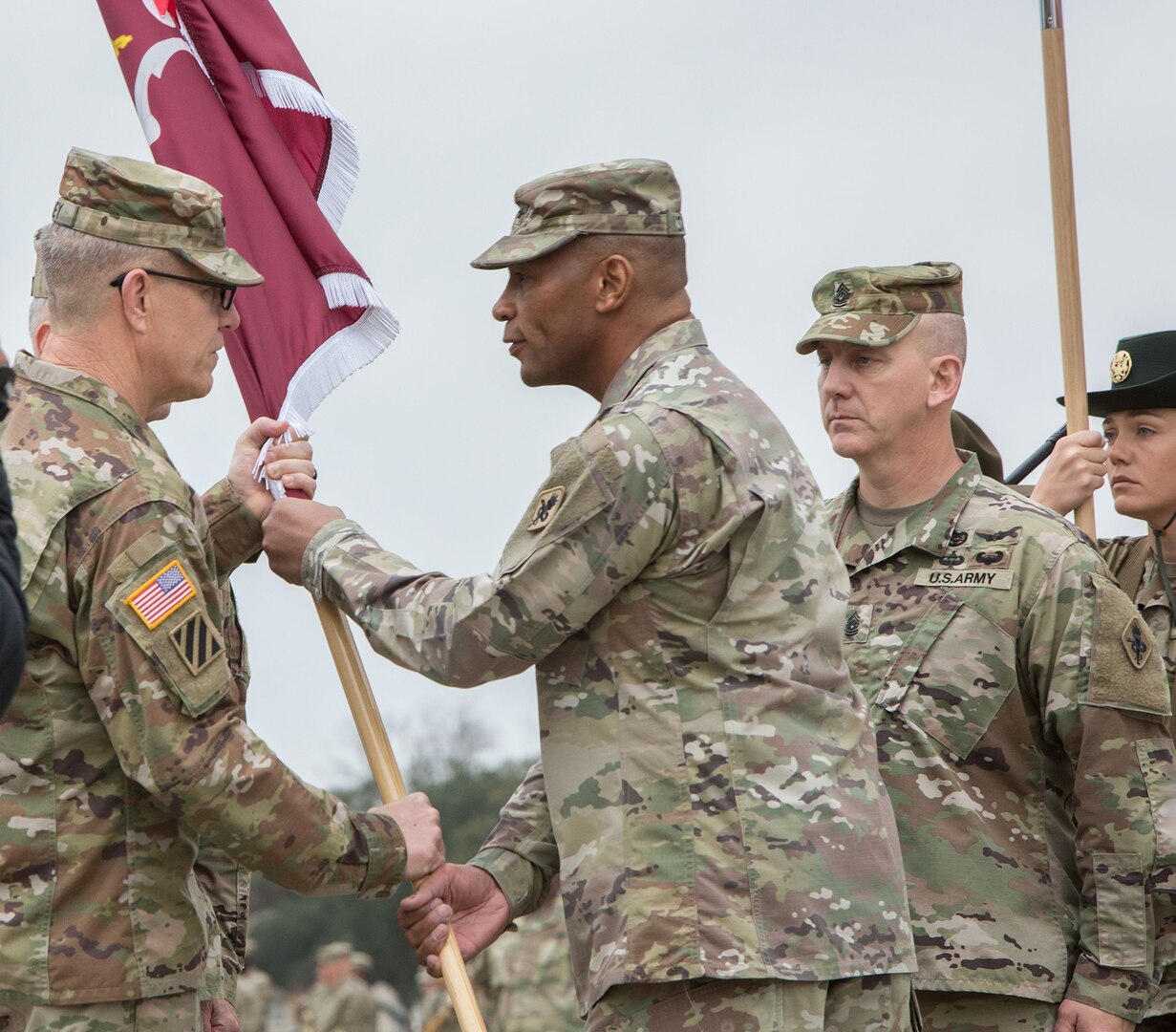 Lt. Gen. James E. Rainey (left), commanding general, U.S. Army Combined Arms Center, accepts the MEDCoE colors from outgoing commander Maj. Gen. Patrick D. Sargent  during the U.S. Army Medical Center of Excellence change of command ceremony at Joint Base San Antonio-Fort Sam Houston Jan. 10.