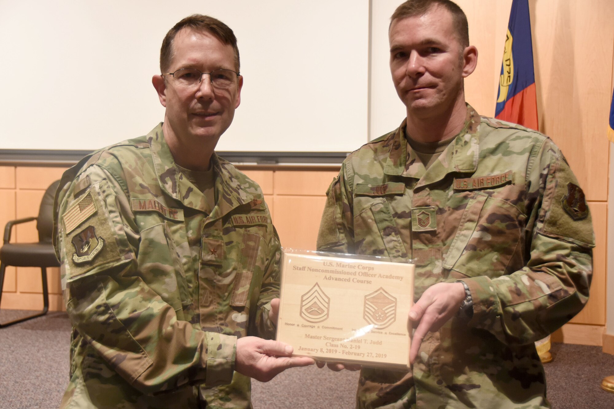 U.S. Air Force Brig. Gen. Stephen Mallette (left), the North Carolina assistant adjutant general for air, presents Master Sgt. Daniel Judd (right), 263rd Combat Communications Squadron,  with an award during an all-call held at the North Carolina Air National Guard headquarters, Jan. 12, 2020. Judd attended the United States Marine Corps Staff Non-Commissioned Officer Academy last year in an effort to better understand the traditions and customs of a sister service. (U.S. Air National Guard photo by Staff Sgt. Laura Montgomery)
