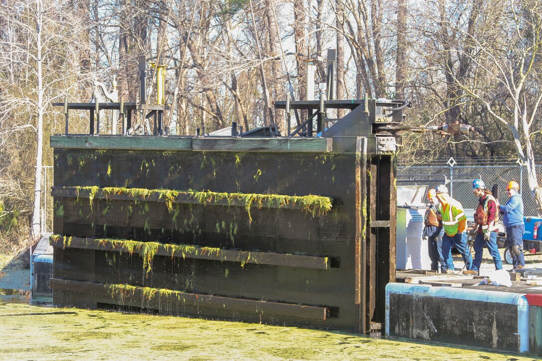 Work crews remove one of two canal gates for refurbishment at South Mills Lock in North Carolina, Jan. 7, 2020.