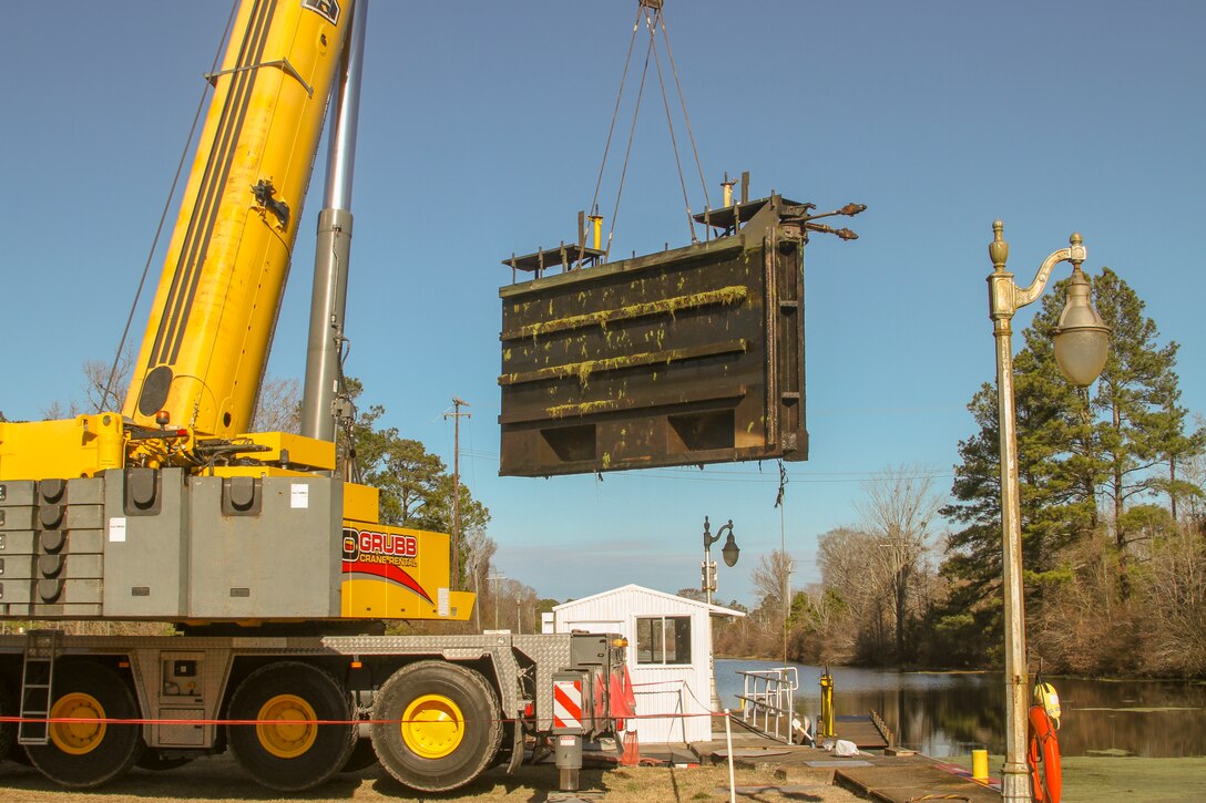 Work crews remove one of two canal gates for refurbishment at South Mills Lock in North Carolina, Jan. 7, 2020.