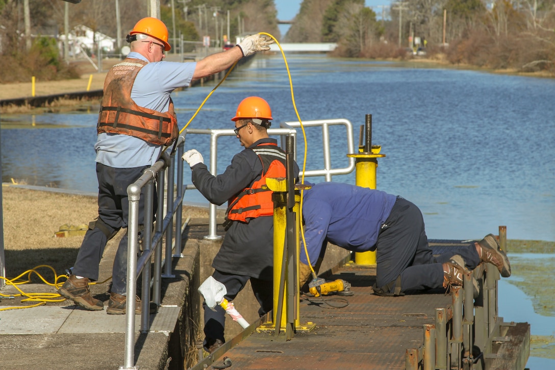 Work crews remove one of two canal gates for refurbishment at South Mills Lock in North Carolina, Jan. 7, 2020.
