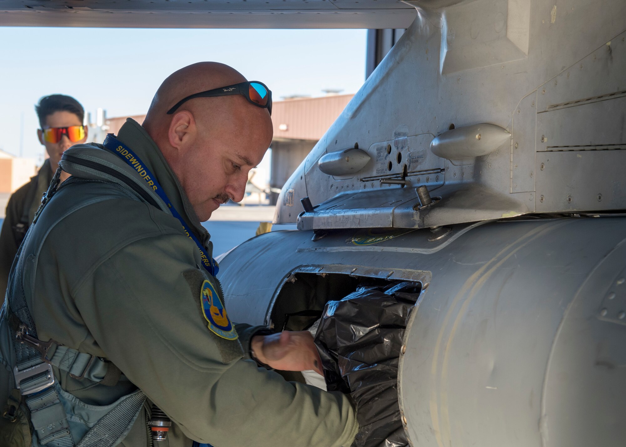 Lt. Col. George Normandin, 311th Fighter Squadron director of operations, loads his bags into a travel pod, Jan. 11, 2020, on Holloman Air Force Base, N.M. Normandin was part of the first group of fighter jet pilots to depart from Holloman for Key West, Fla., to participate in Dissimilar Air Combat Training. (U.S. Air Force photo by Airman 1st Class Autumn Vogt)