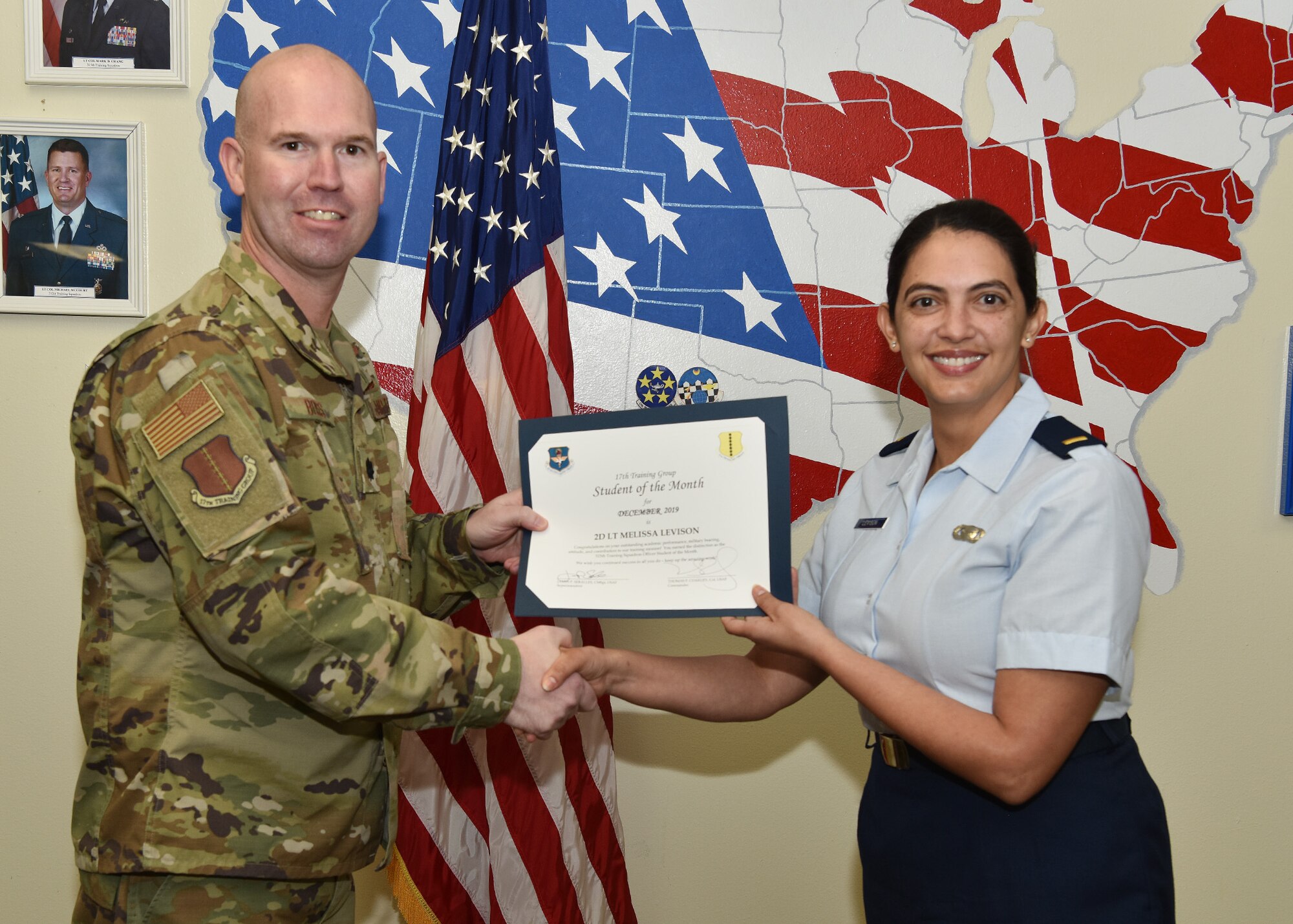 U.S. Air Force Lt. Col. Kevin Boss, 17th Training Group deputy commander, presents the 315th Training Squadron Officer Student of the Month award to 2nd Lt. Melissa Levison, 315th TRS student, at Brandenburg Hall on Goodfellow Air Force Base, Texas, Jan. 10, 2020. The 315th TRS’s vision is to develop combat-ready intelligence, surveillance and reconnaissance professionals and promote an innovative squadron culture. (U.S. Air Force photo by Staff Sgt. Chad Warren)