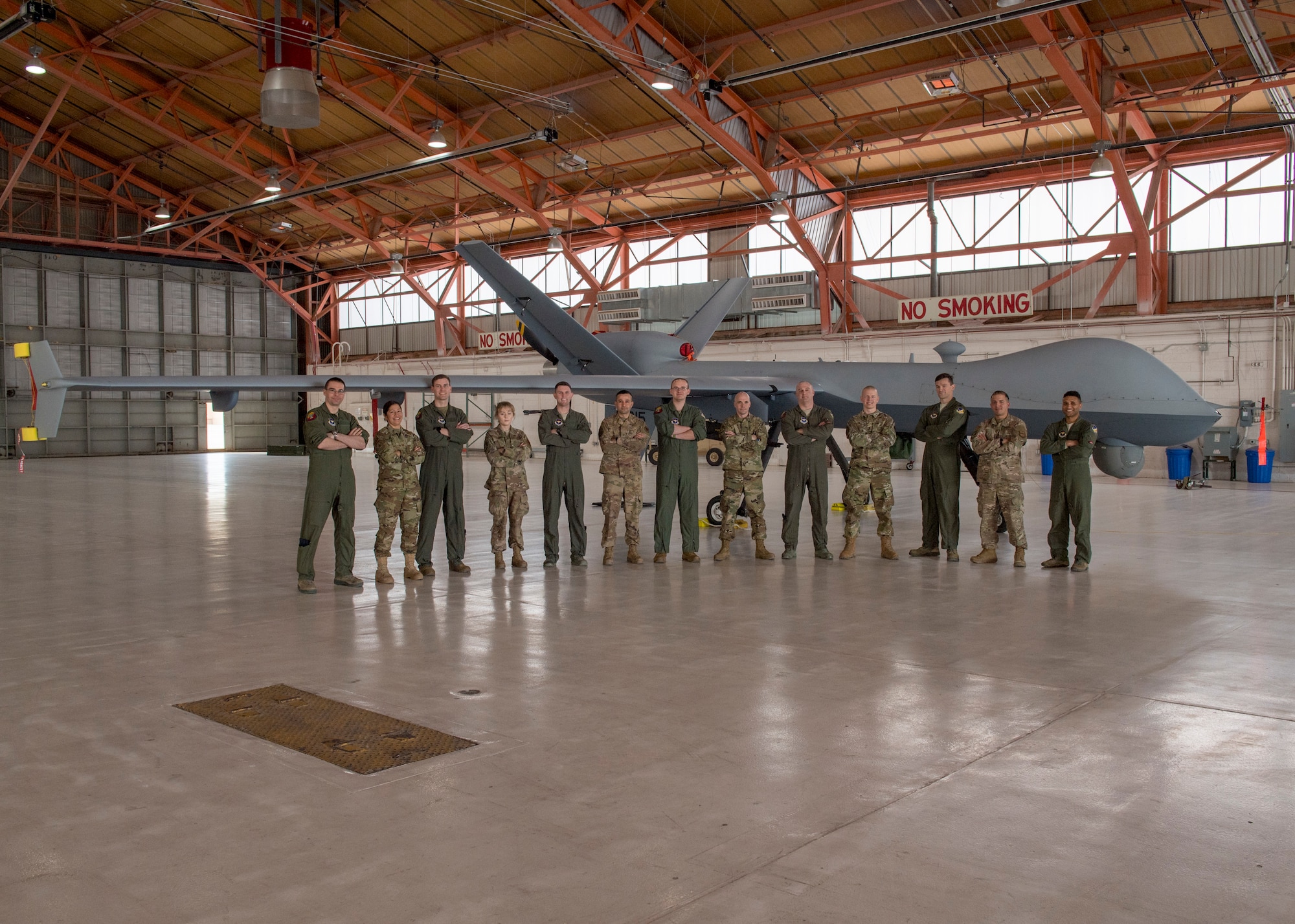 Some of the team who were directly involved the MQ-9 Reaper ferrying mission posed with the aircraft, Jan. 9, 2020, on Holloman Air Force Base, N.M. Airmen from the communications squadron, aircraft maintenance unit, and the 29th Attack Squadron were some of the members who ensured the success of ferrying an MQ-9 from California to Holloman. (U.S. Air Force photo by Airman 1st Class Autumn Vogt)