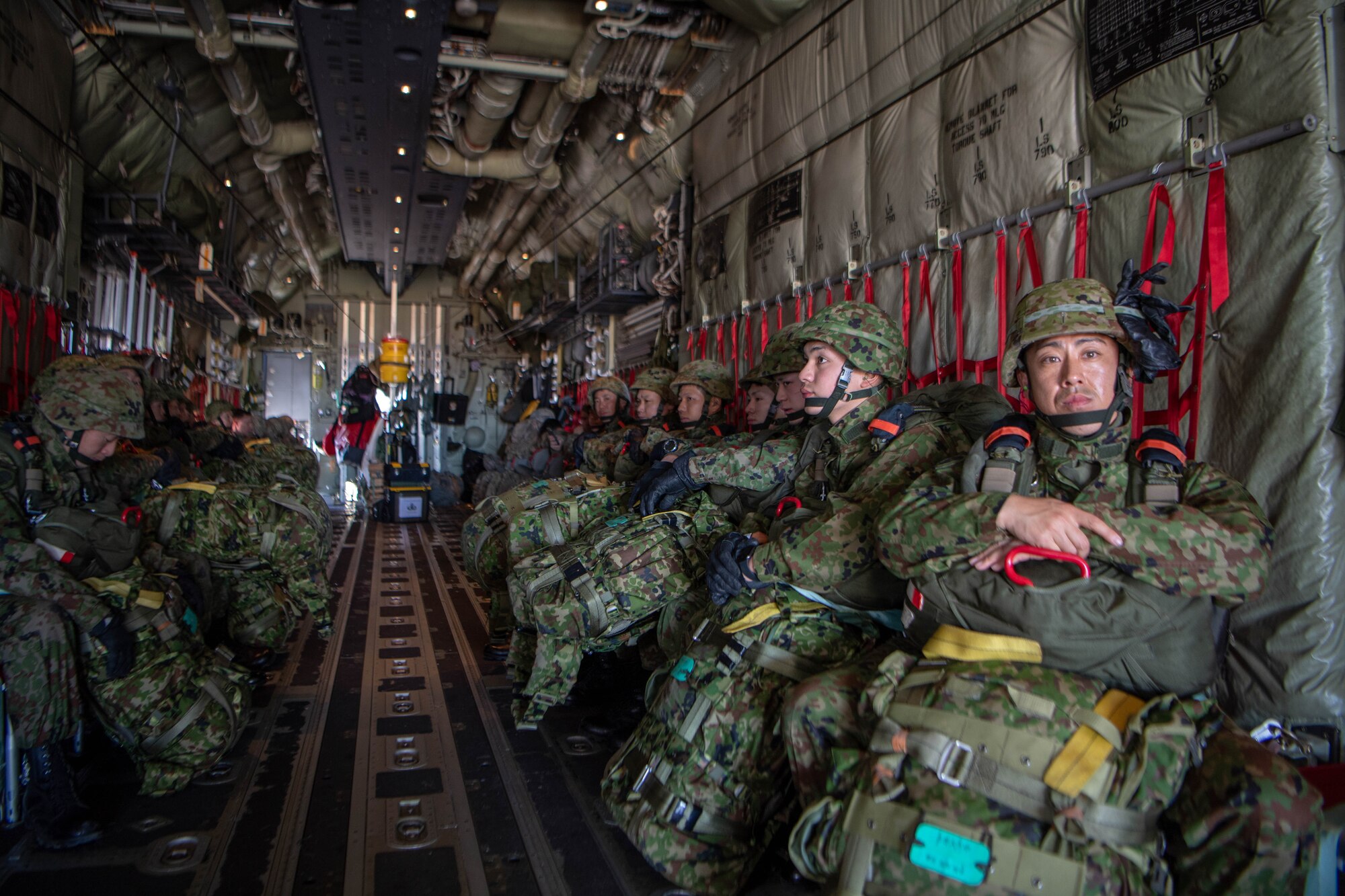 Soldiers and Airmen prepare for New Year Jump aboard U.S. Air Force C-130J Super Hercules.