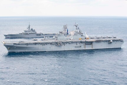 Amphibious assault ship USS America (LHA 6) and Japan Maritime Self-Defense Force amphibious transport dock ship JS Kunisaki (LST 4003) operate together in the East China Sea.
