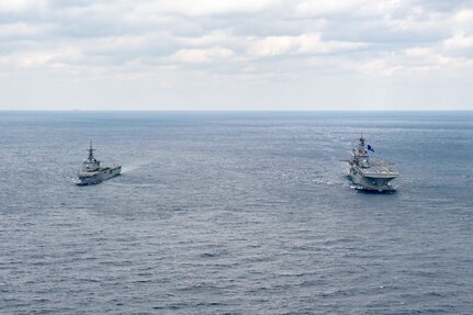 Amphibious assault ship USS America (LHA 6) and Japan Maritime Self-Defense Force amphibious transport dock ship JS Kunisaki (LST 4003) operate together in the East China Sea.