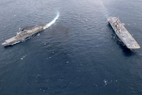 Amphibious assault ship USS America (LHA 6) and Japan Maritime Self-Defense Force amphibious transport dock ship JS Kunisaki (LST 4003) operate together in the East China Sea.