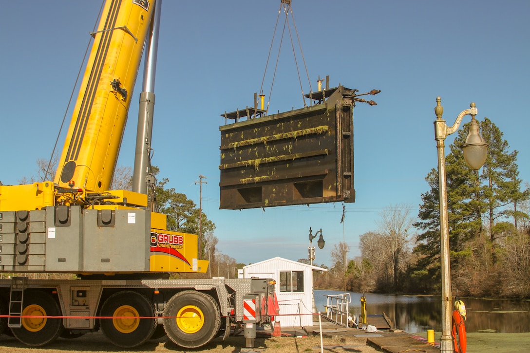 Work crews remove one of two canal gates for refurbishment at South Mills Lock in North Carolina, Jan. 7, 2020.