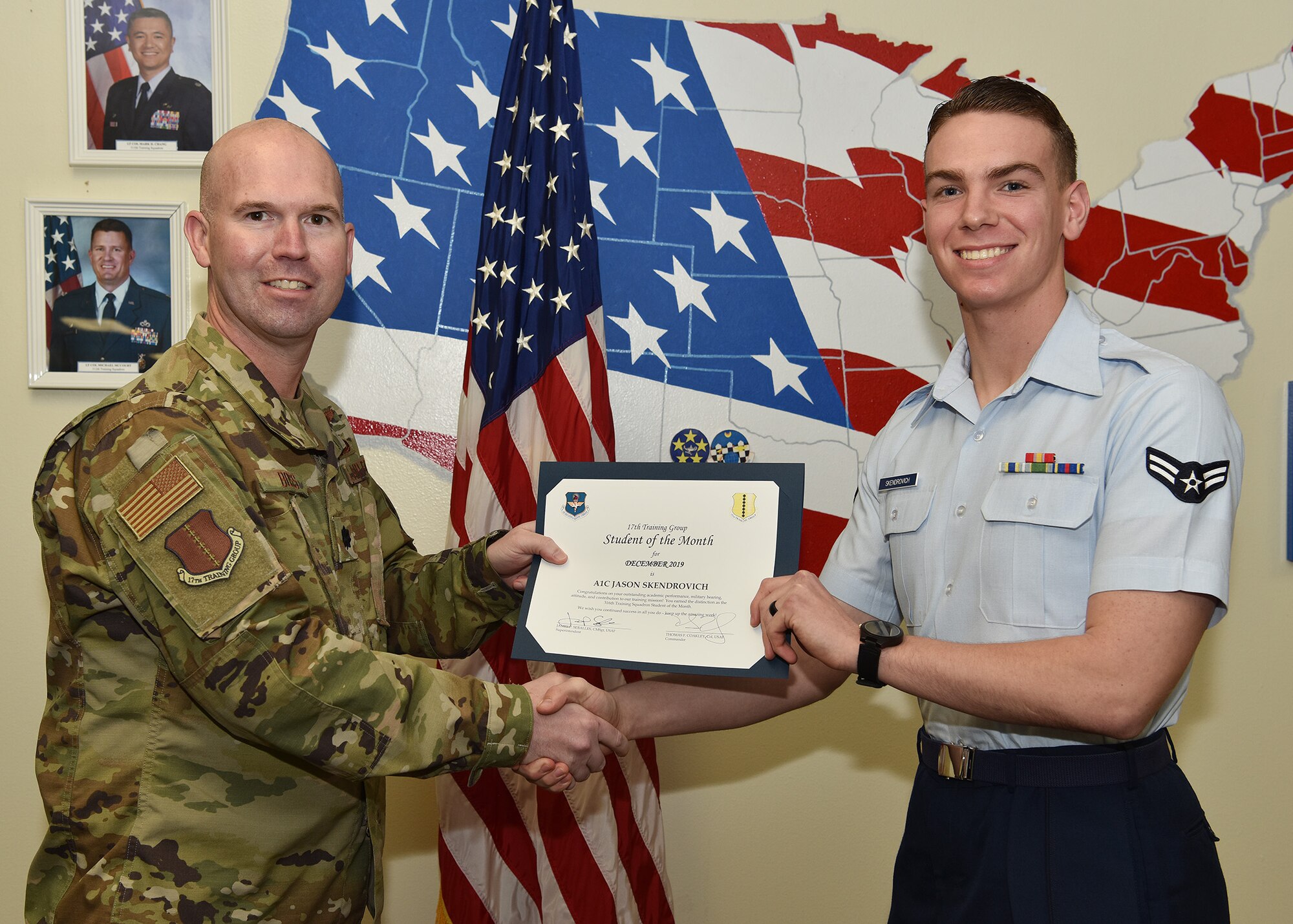 U.S. Air Force Lt. Col. Kevin Boss, 17th Training Group deputy commander, presents the 316th Training Squadron Student of the Month award to Airman 1st Class Jason Skendrovich, 316th TRS student, at Brandenburg Hall on Goodfellow Air Force Base, Texas, Jan. 10, 2019. The 316th TRS’s mission is to conduct U.S. Air Force, U.S. Army, U.S. Marine Corps, U.S. Navy and U.S. Coast Guard cryptologic, human intelligence and military training. (U.S. Air Force photo by Staff Sgt. Chad Warren)