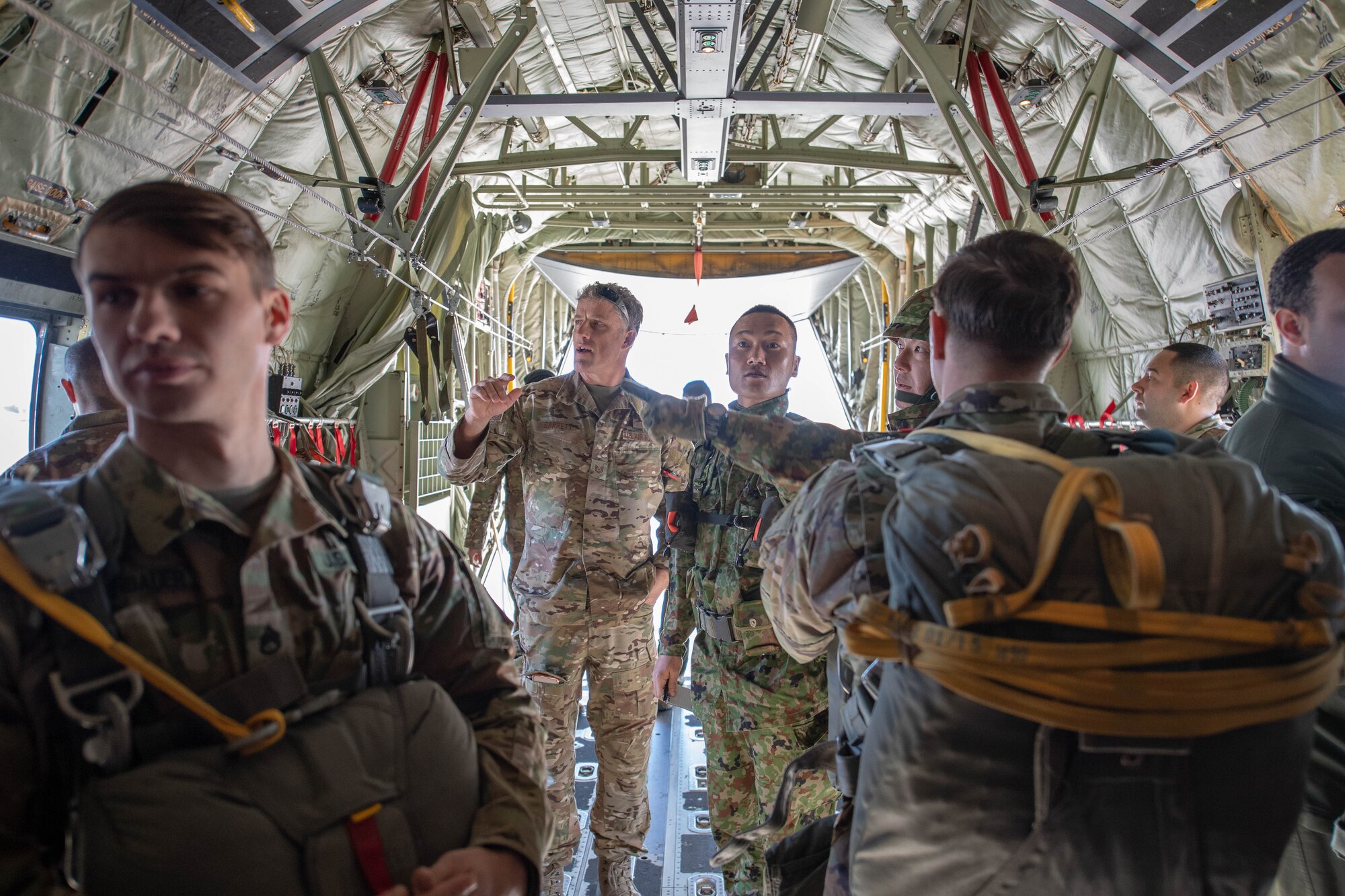 Soldiers and Airmen prepare for New Year Jump aboard U.S. Air Force C-130J Super Hercules.