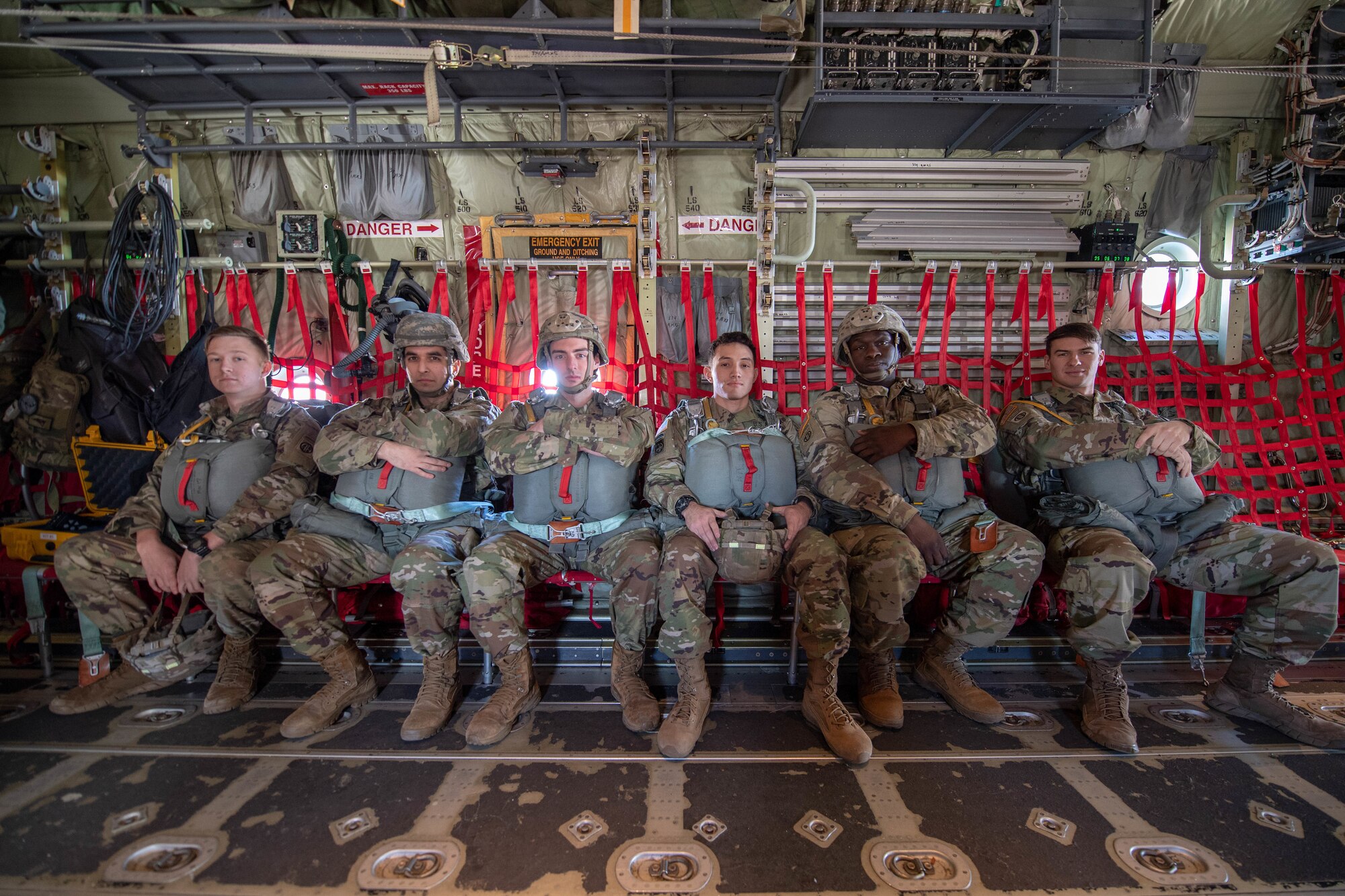 U.S. Army Reserve Alaska & 82nd Airborne soldiers sit inside C-130J Super Hercules.