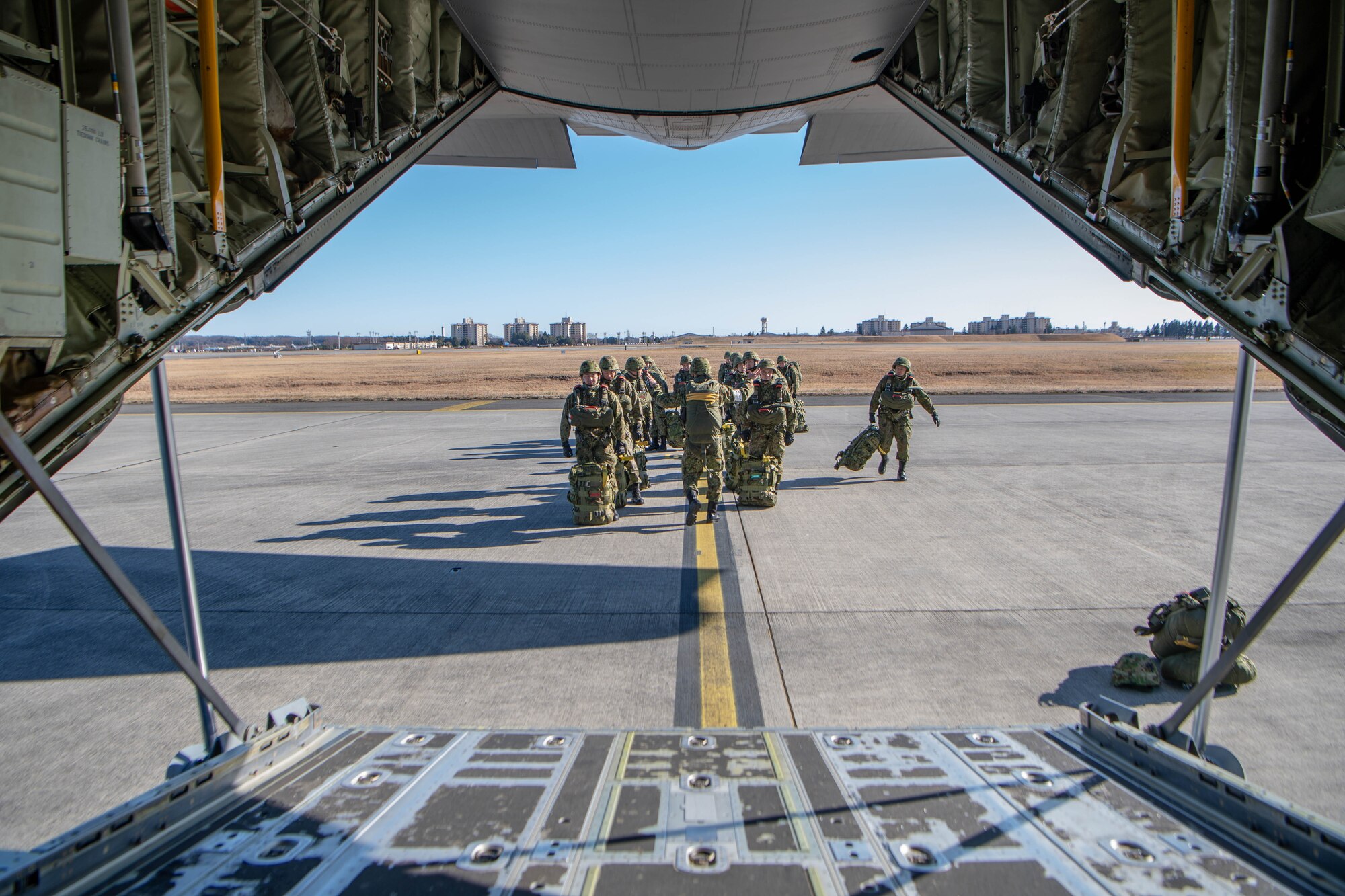 JDSDF Soldiers gather outside of C-130J Super Hercules in preparation of New Year's Jump.