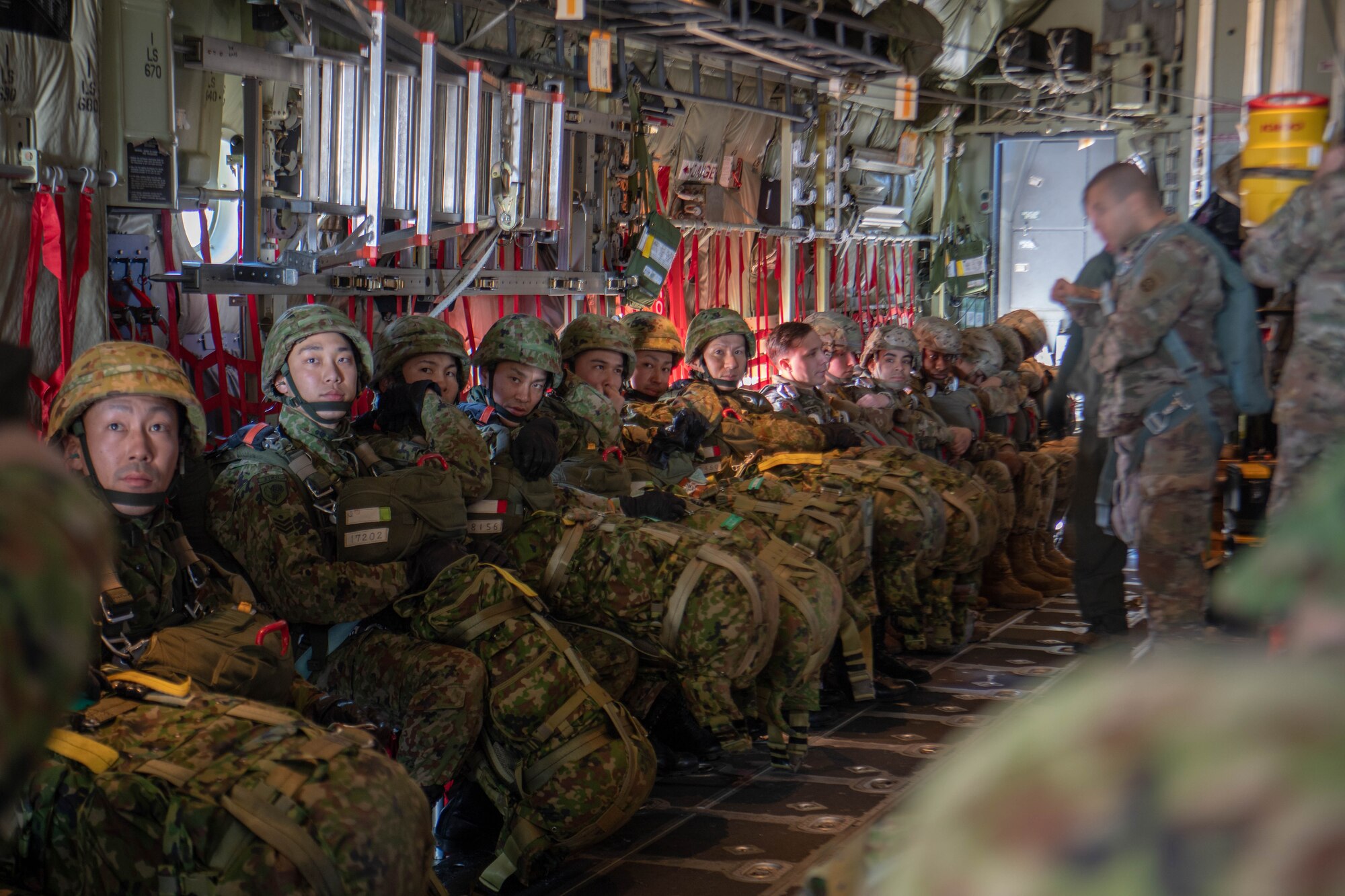 Soldiers and Airmen prepare for New Year Jump aboard U.S. Air Force C-130J Super Hercules.