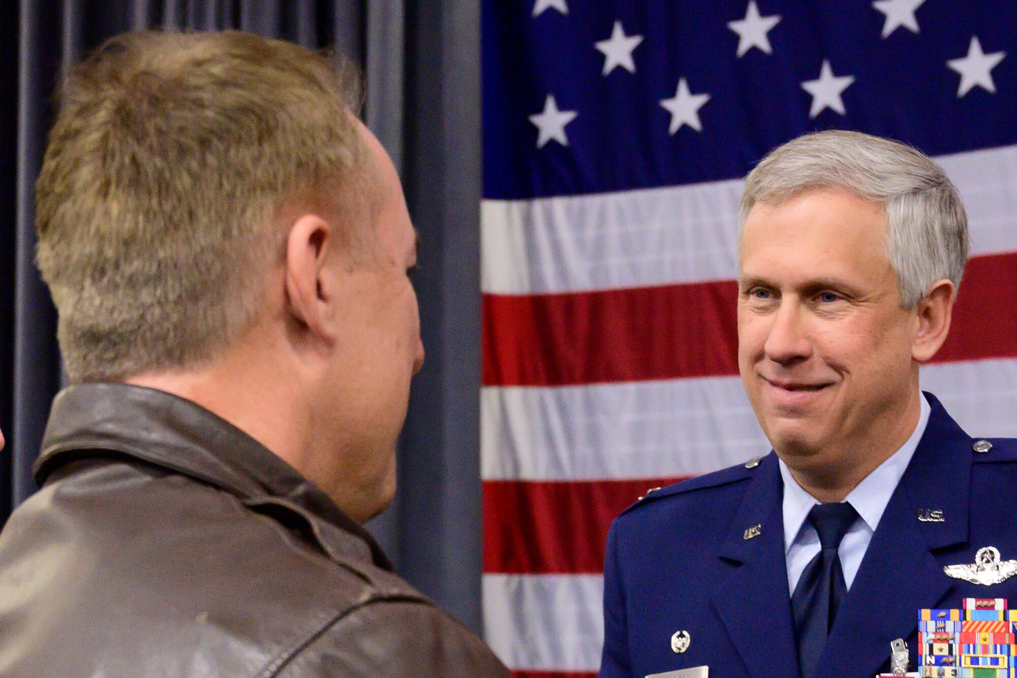 Photo of two Airmen speaking.